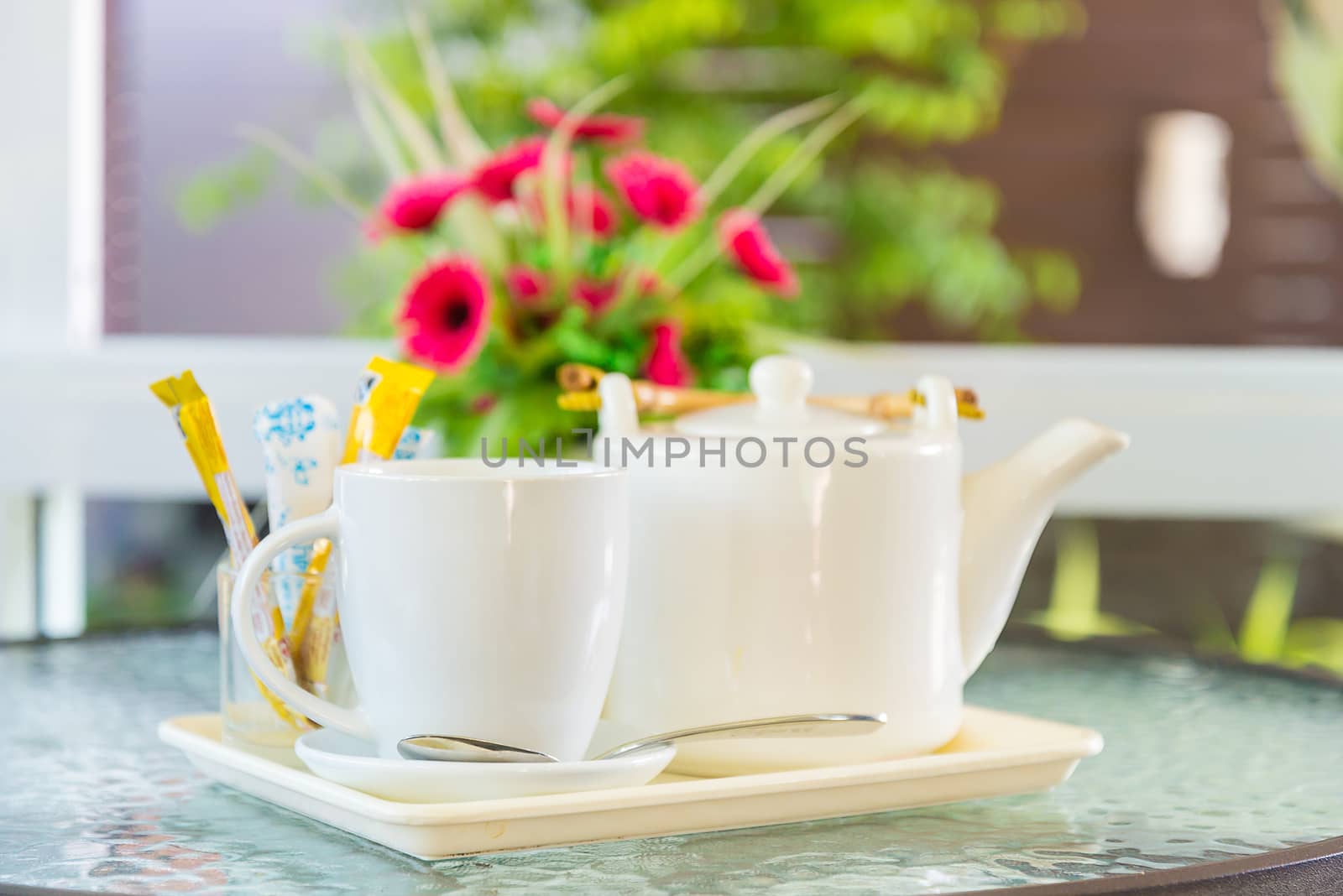 Hot coffee and a teapot on the table.