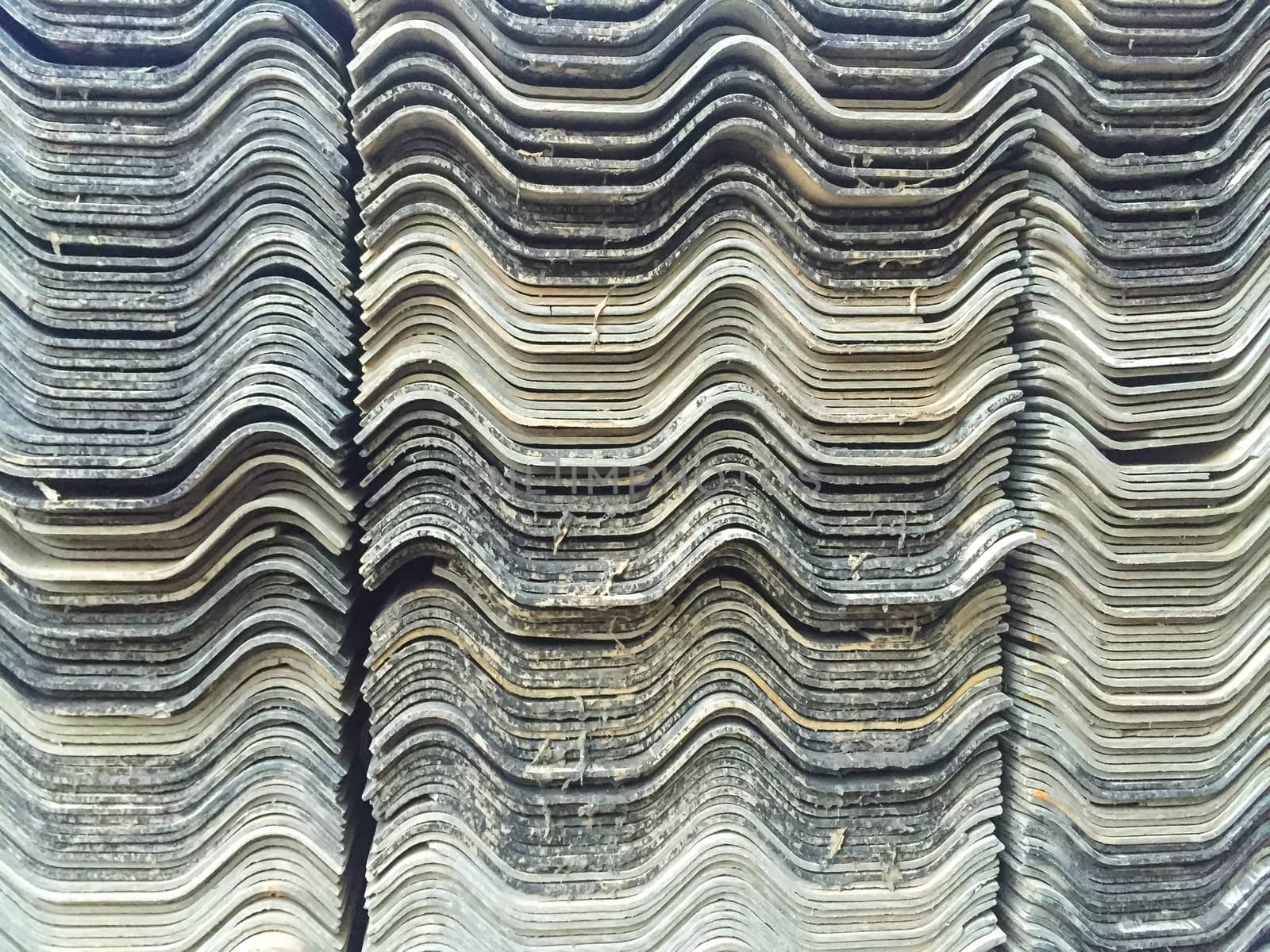 Stacks of old roof tiles, texture background.