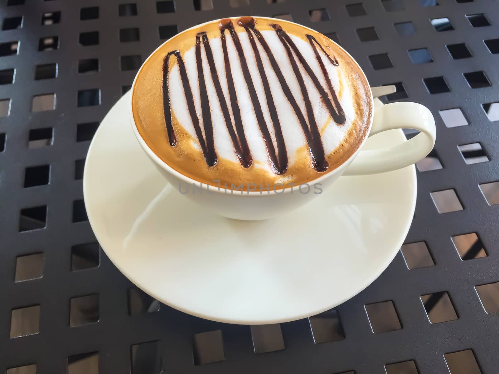 Hot coffee in white cup on the  table.