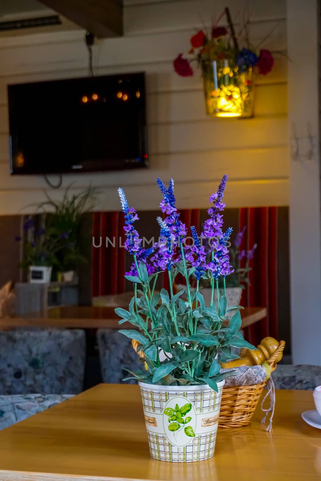 Flower decoration in cafe, Latvia. Flowers in a vase. Cafe interior with flowers. Flower vase decor on the table. 


