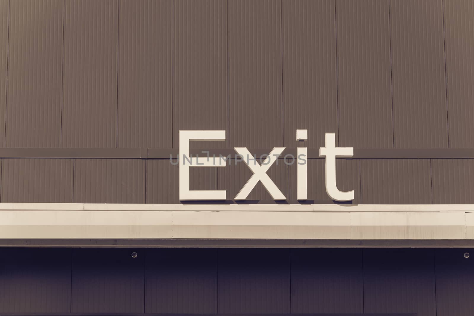Filtered image exit sign close-up on blue background by trongnguyen