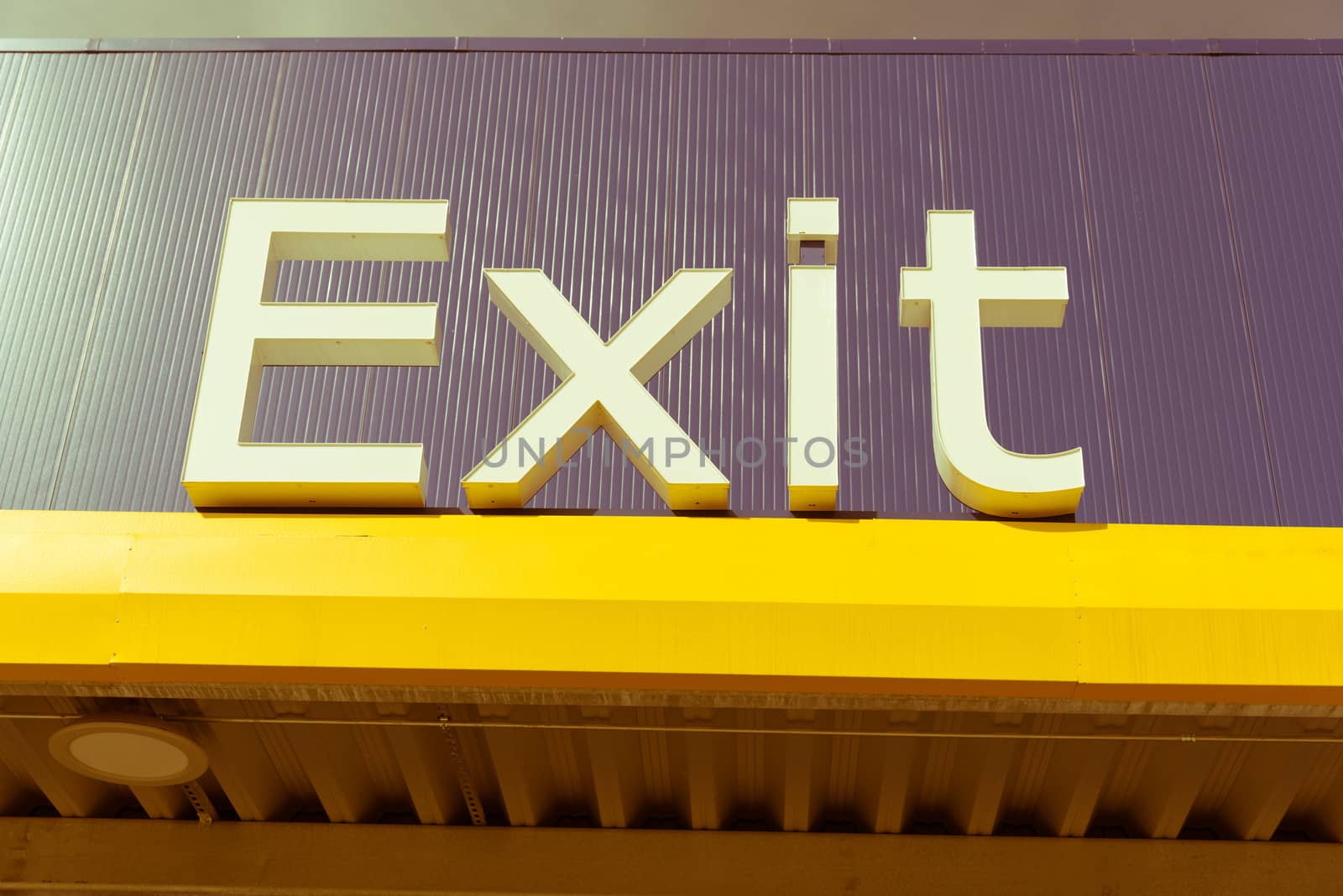 Vintage tone close-up of outdoor exit sign on building facade