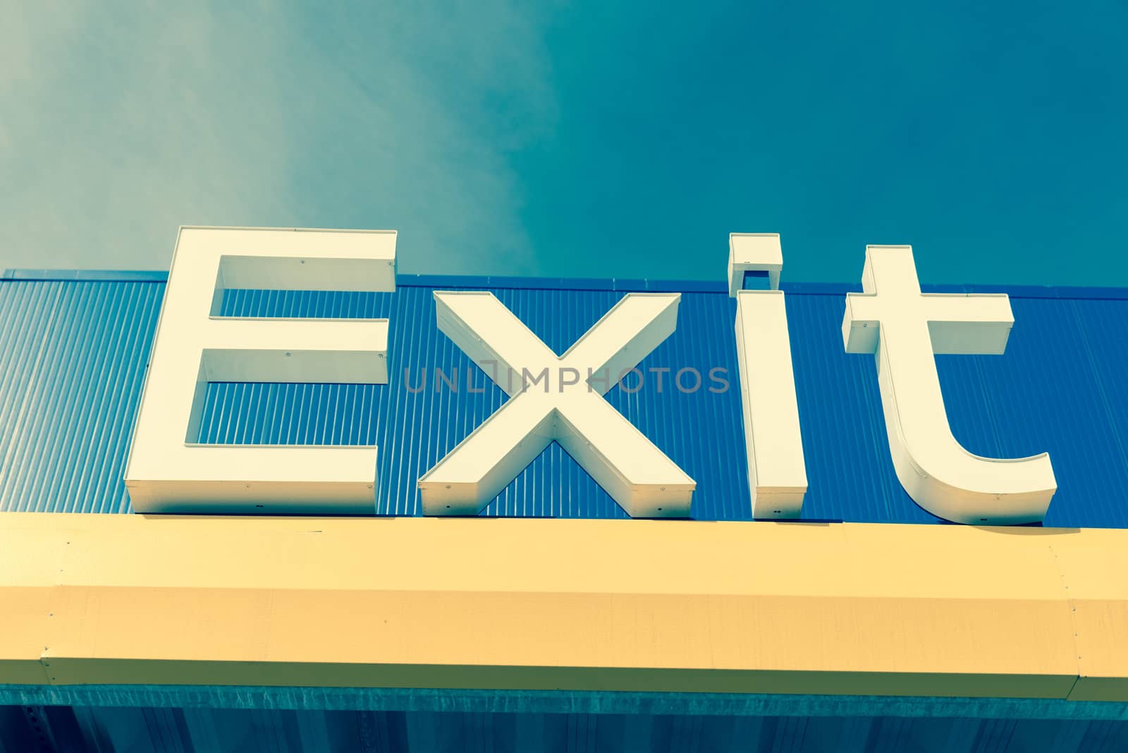 Lookup view to Exit sign again cloud blue sky