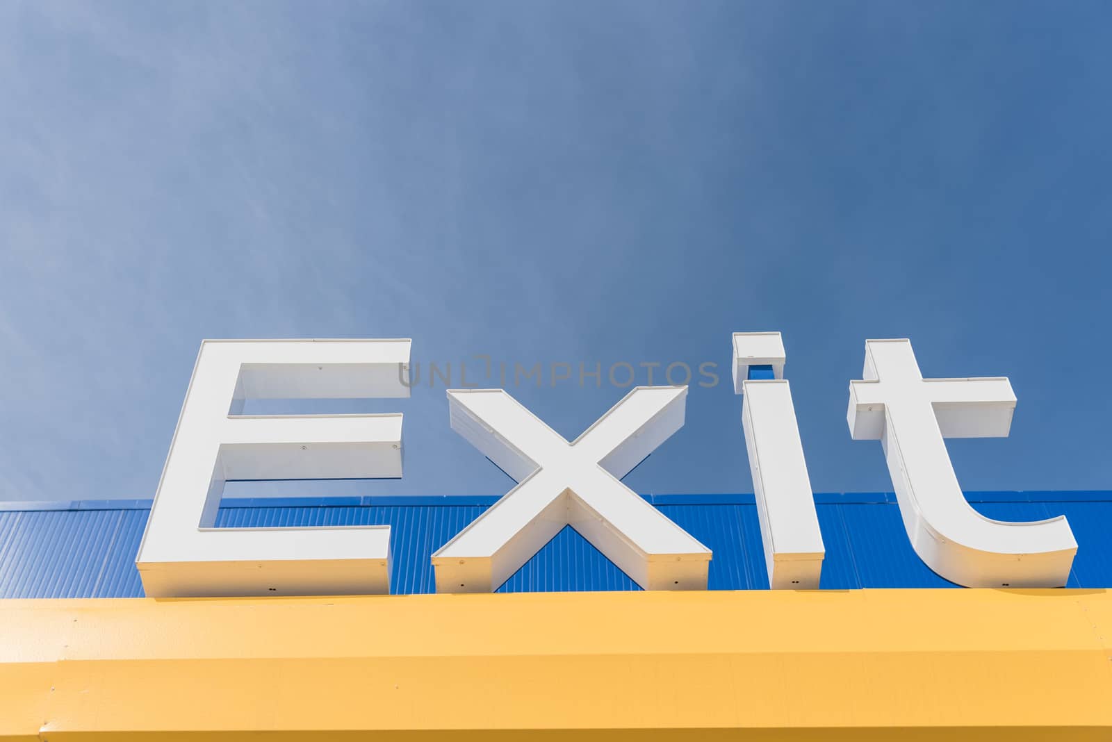 Low-angle view of Exit sign again blue sky by trongnguyen