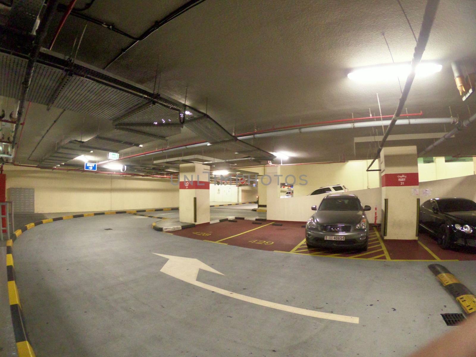 Numbered Parking Lot in Dubai Basement with two cars.