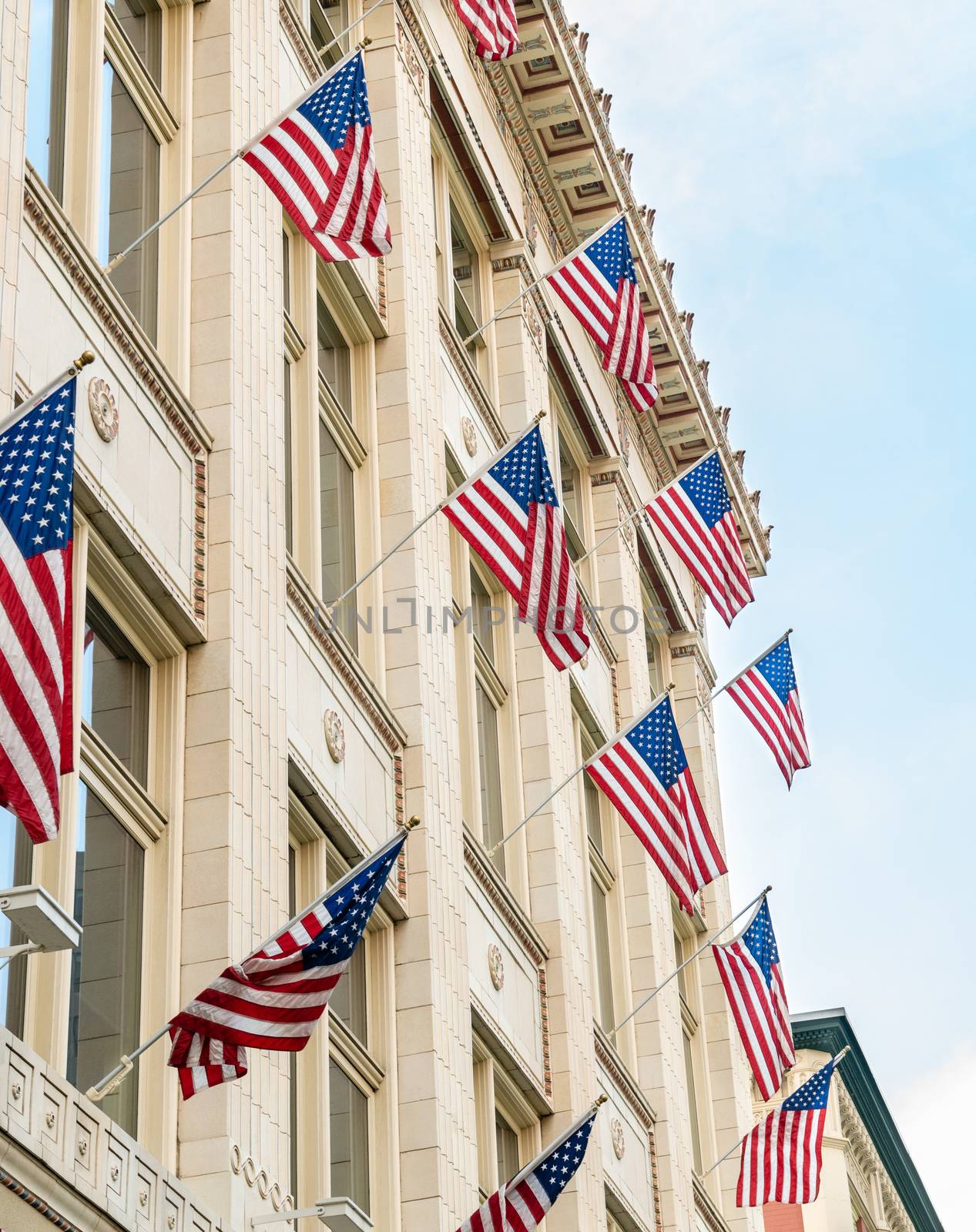 American flags hung off side of building complex in Denver, Colorado by Njean