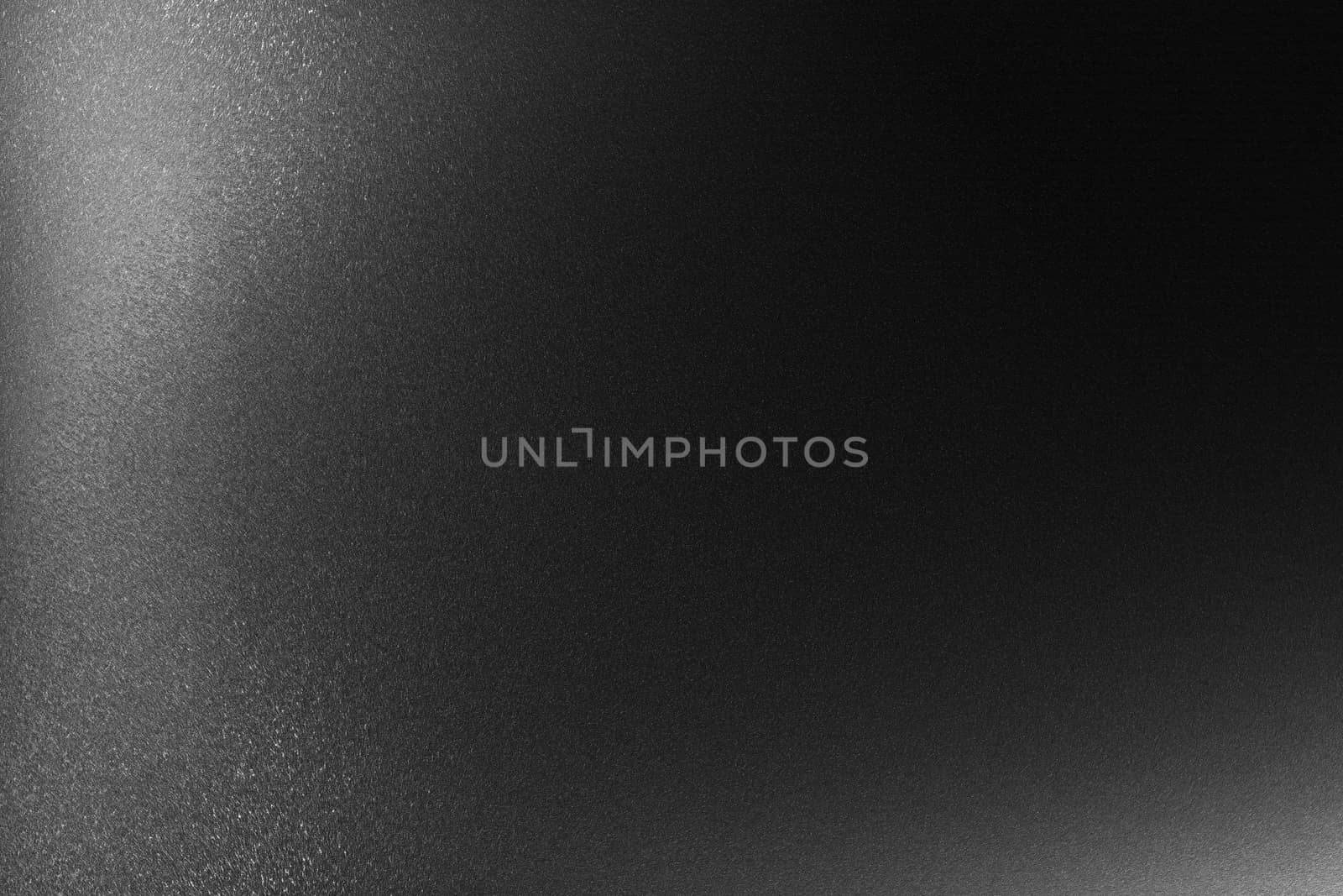 Texture of black hard steel in the dark background