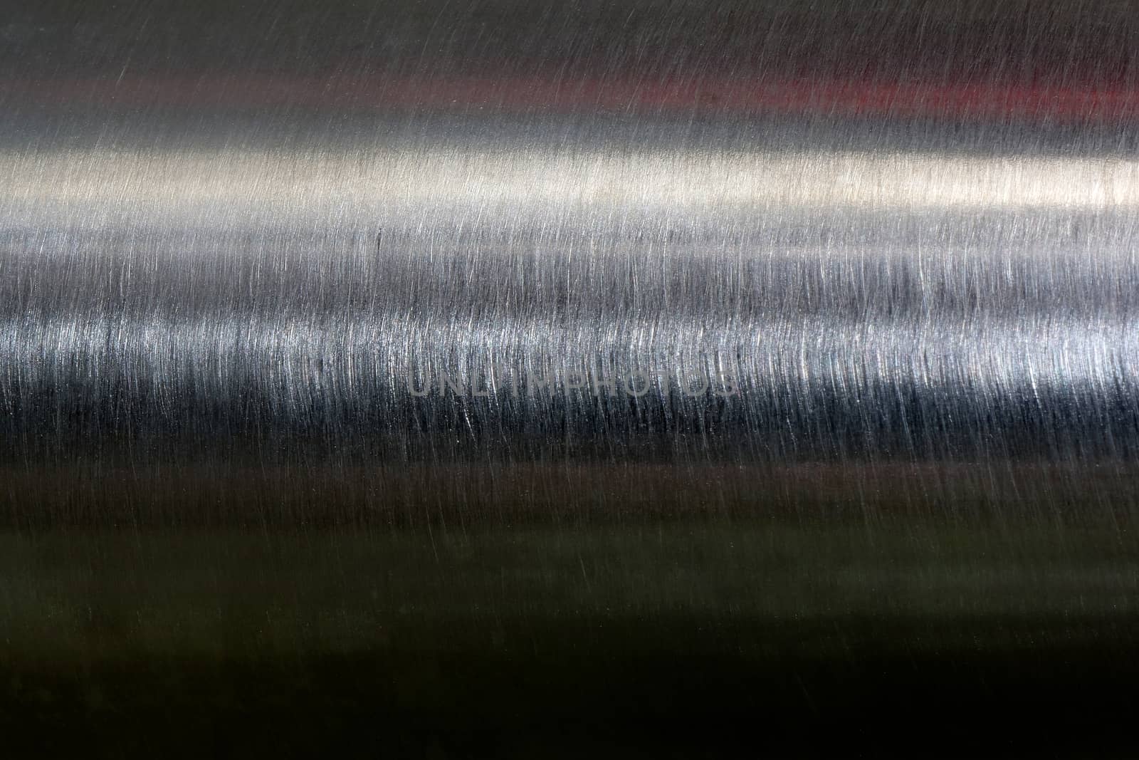 Texture of reflection on stainless steel pipe in dark room, abstract background