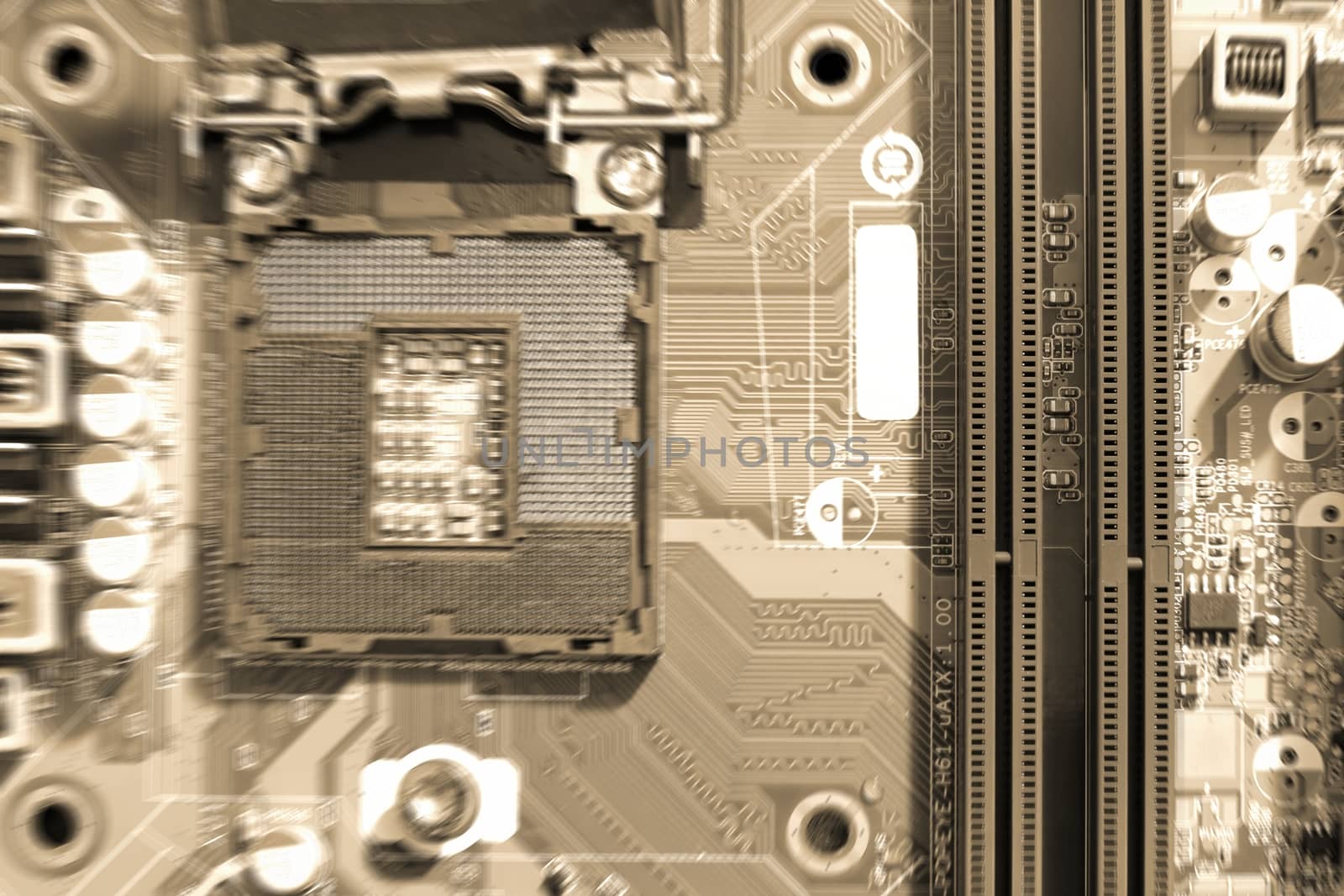 Electronic circuit boards on brown background with RAM connector slot and CPU socket, selective focus