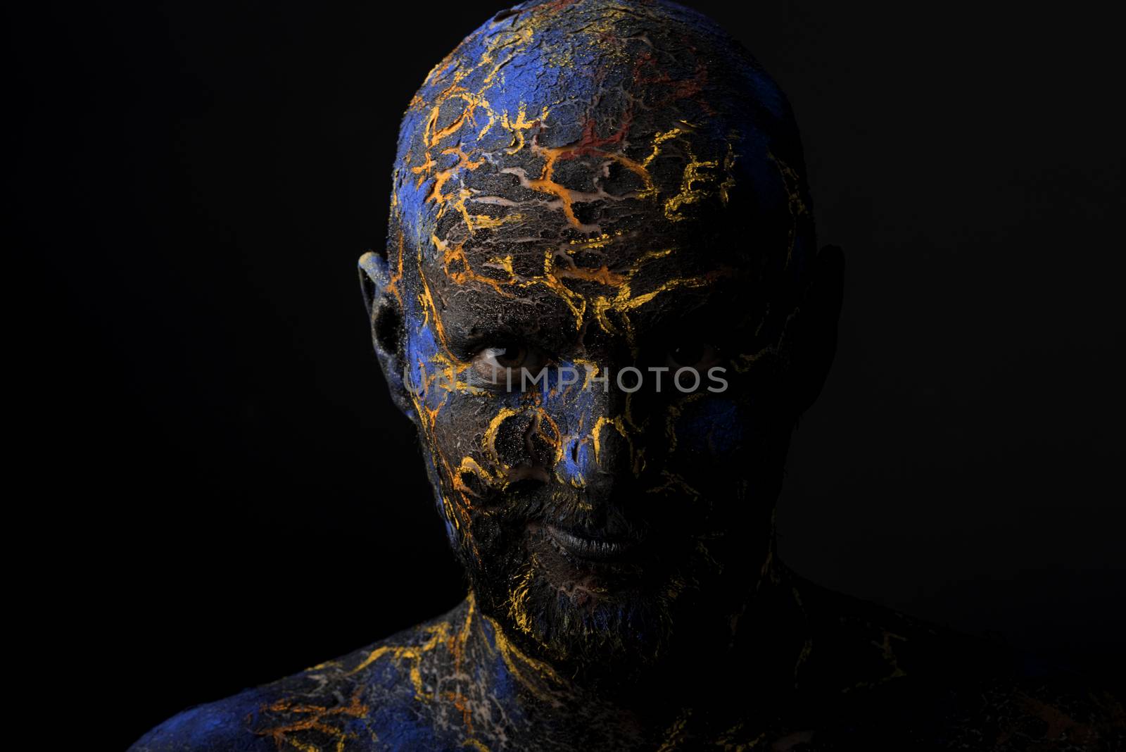 Conceptual Portrait of a brutal man painted in face art style over black background