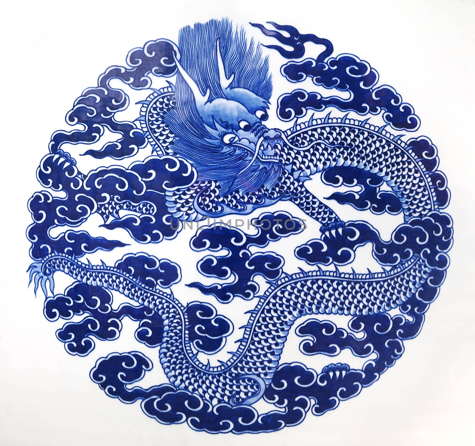 Chinese dragon painted on a ceramic vase with cobalt blue glaze