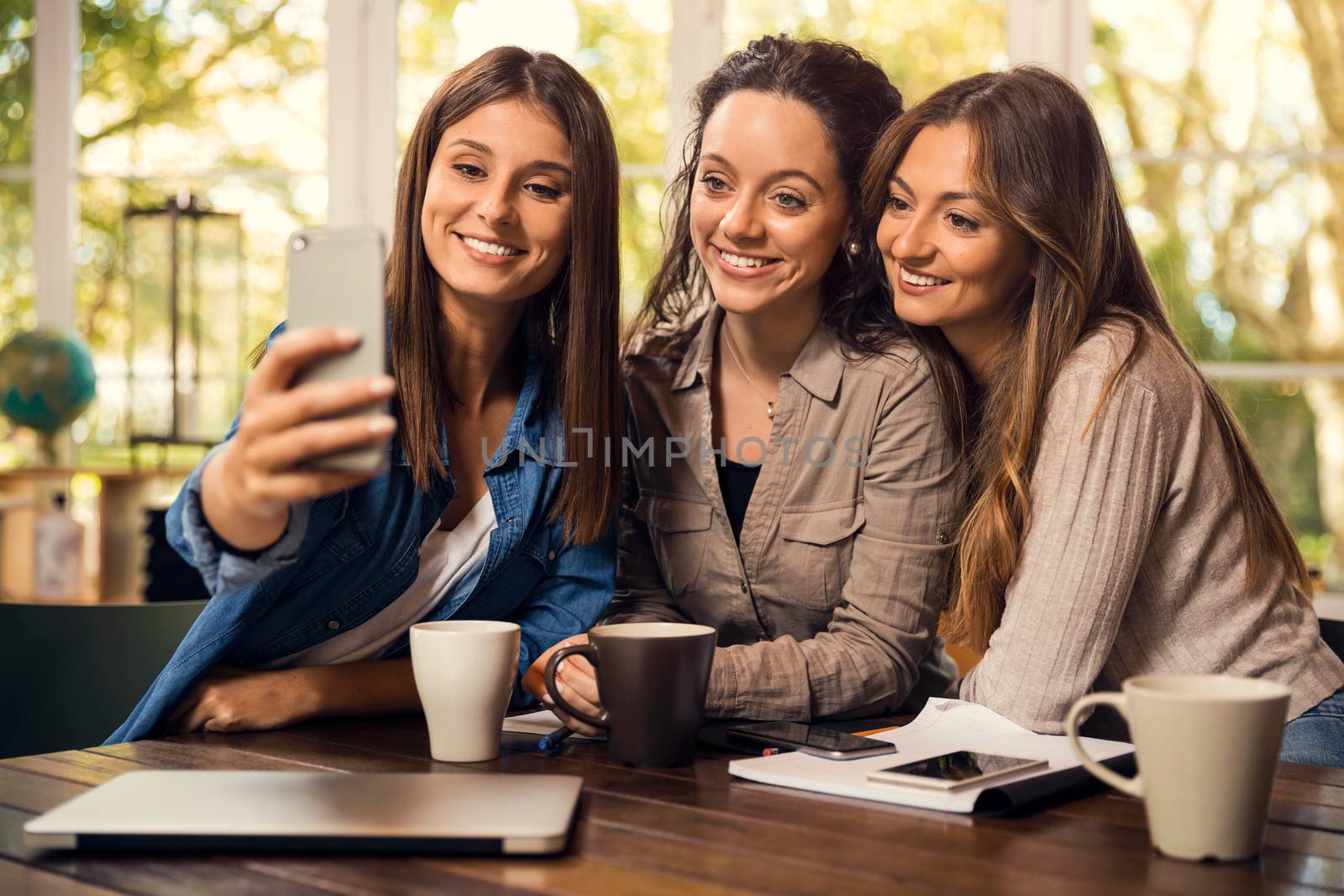 Groups of female firends making a selfie during a pause on the studies