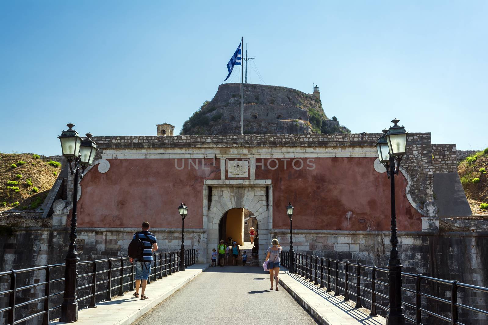 Corfu, Greece - August 25, 2018: Fortezza Vecchia (Old Fortress, Corfu) entrance with tourists on the bridge.