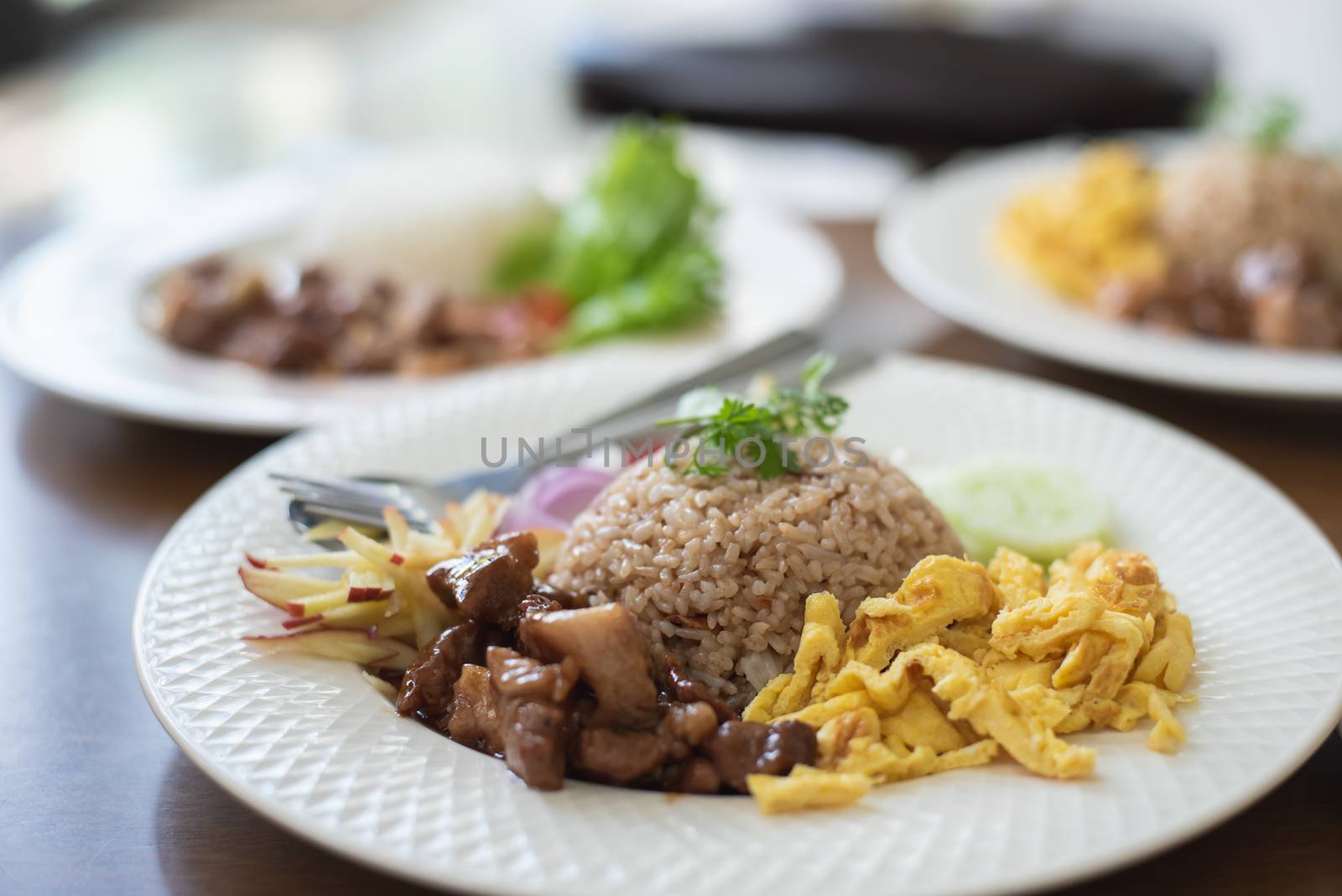 fire rice with pork and fire egg on wood table