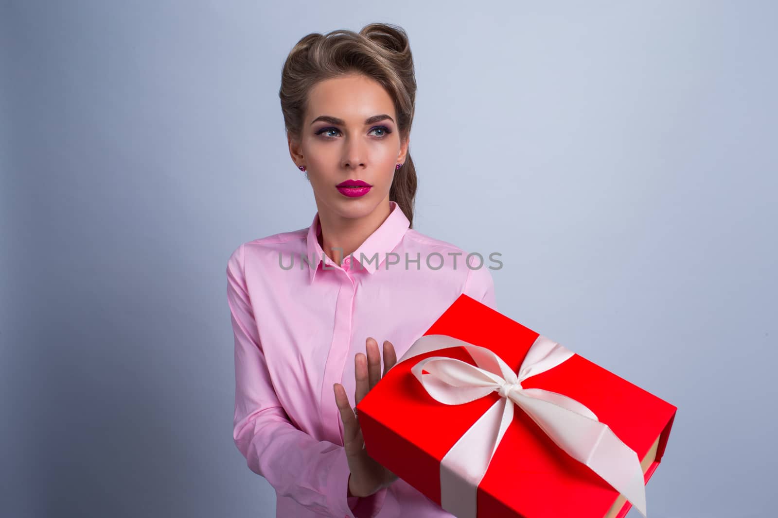 Portrait of a young woman refusing holiday gift box