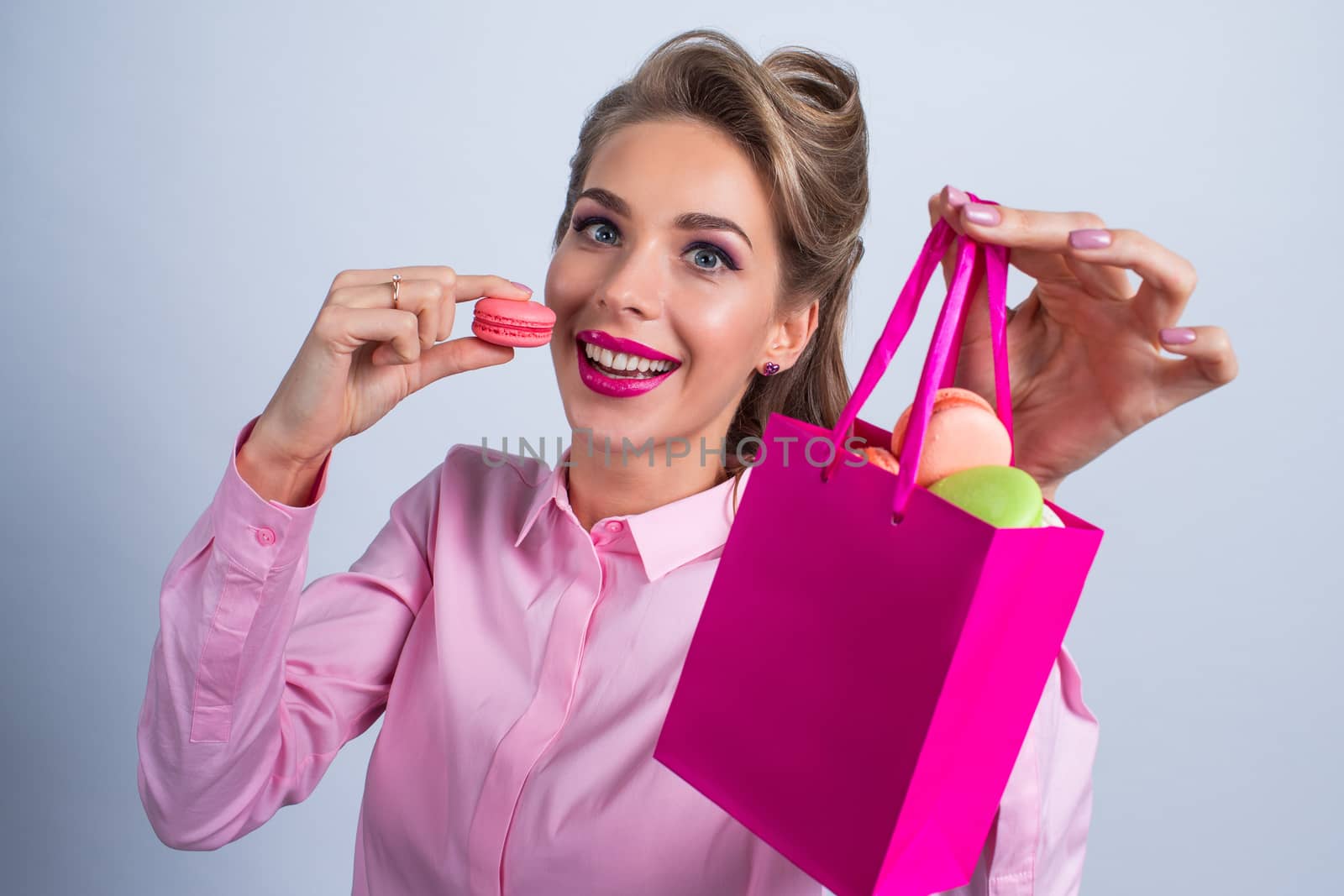 Woman eating macaroons by ALotOfPeople