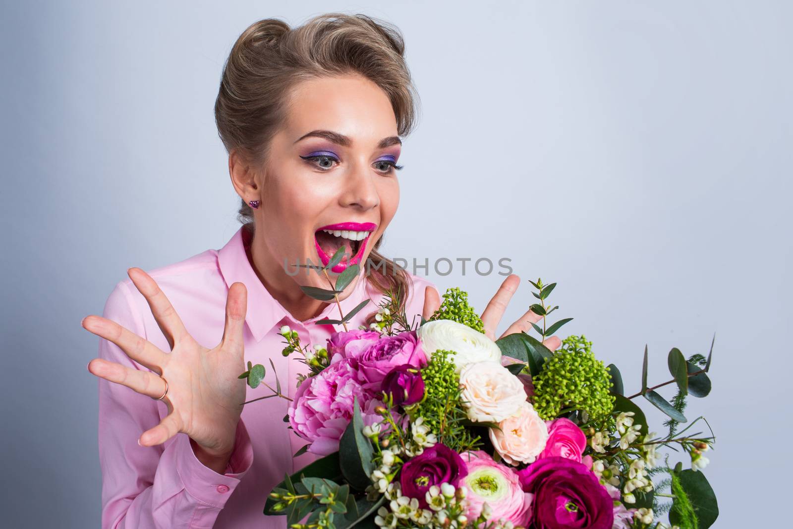 Woman surprised with bunch of flowers, funny emotional expression