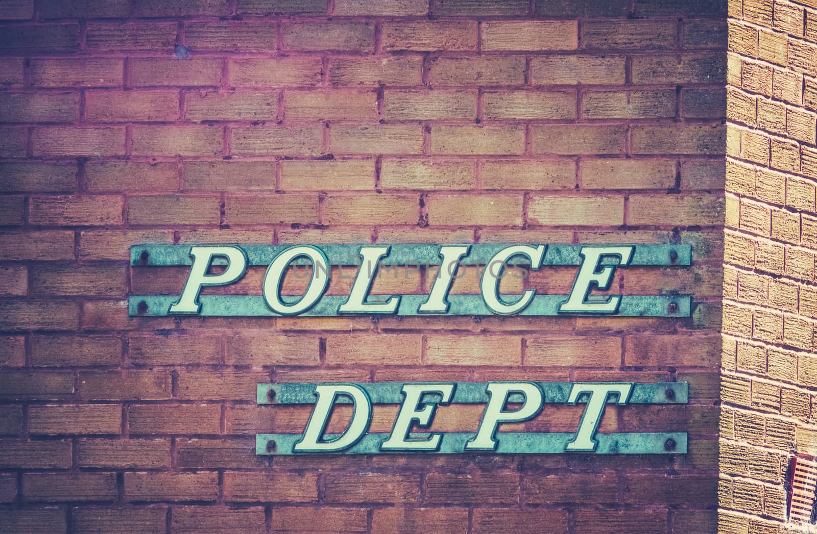 Retro Vintage Sign For A Police Department Or Station On A Red Brick Building In Small Town USA