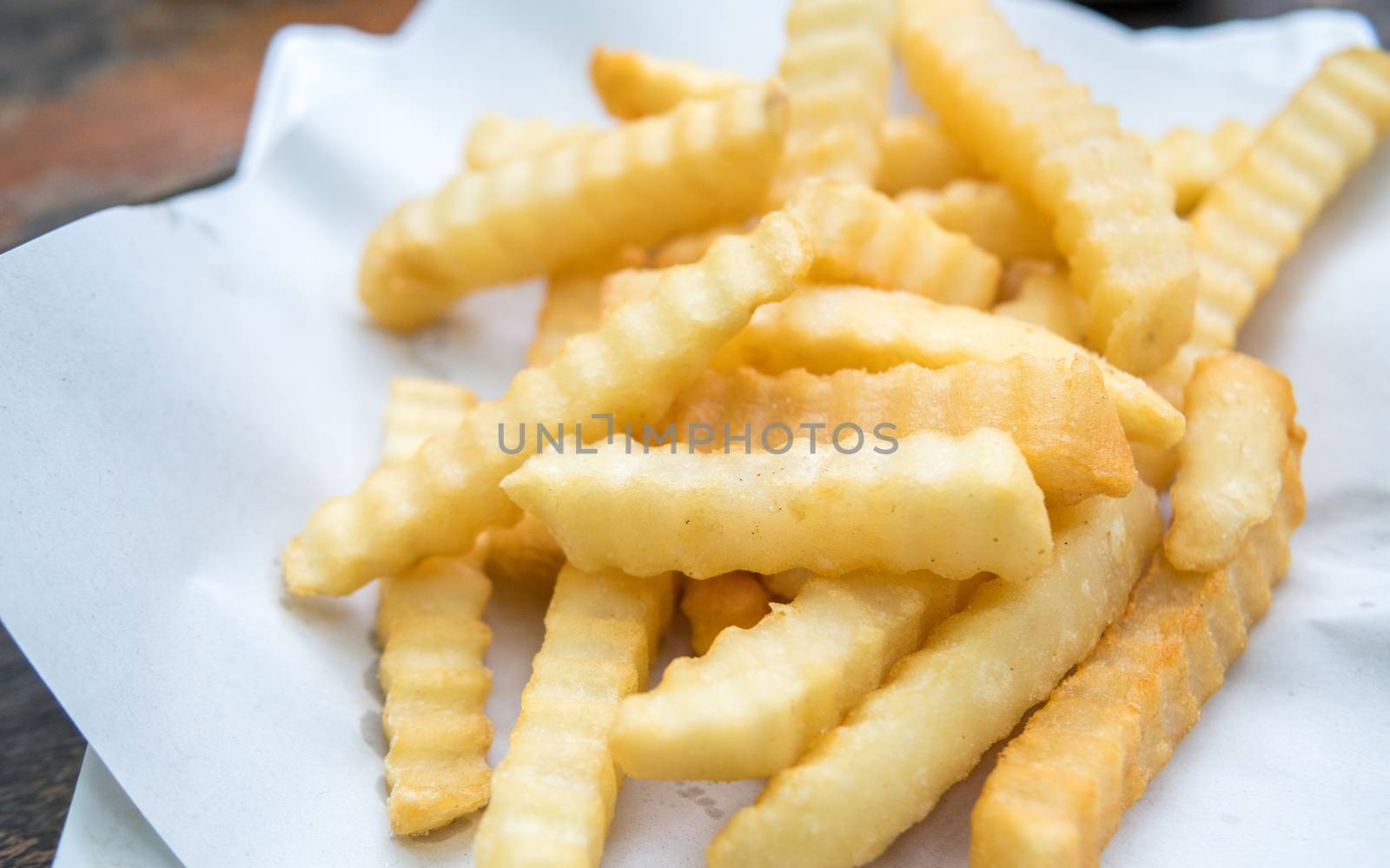 potatoes fries on a white paper by antpkr
