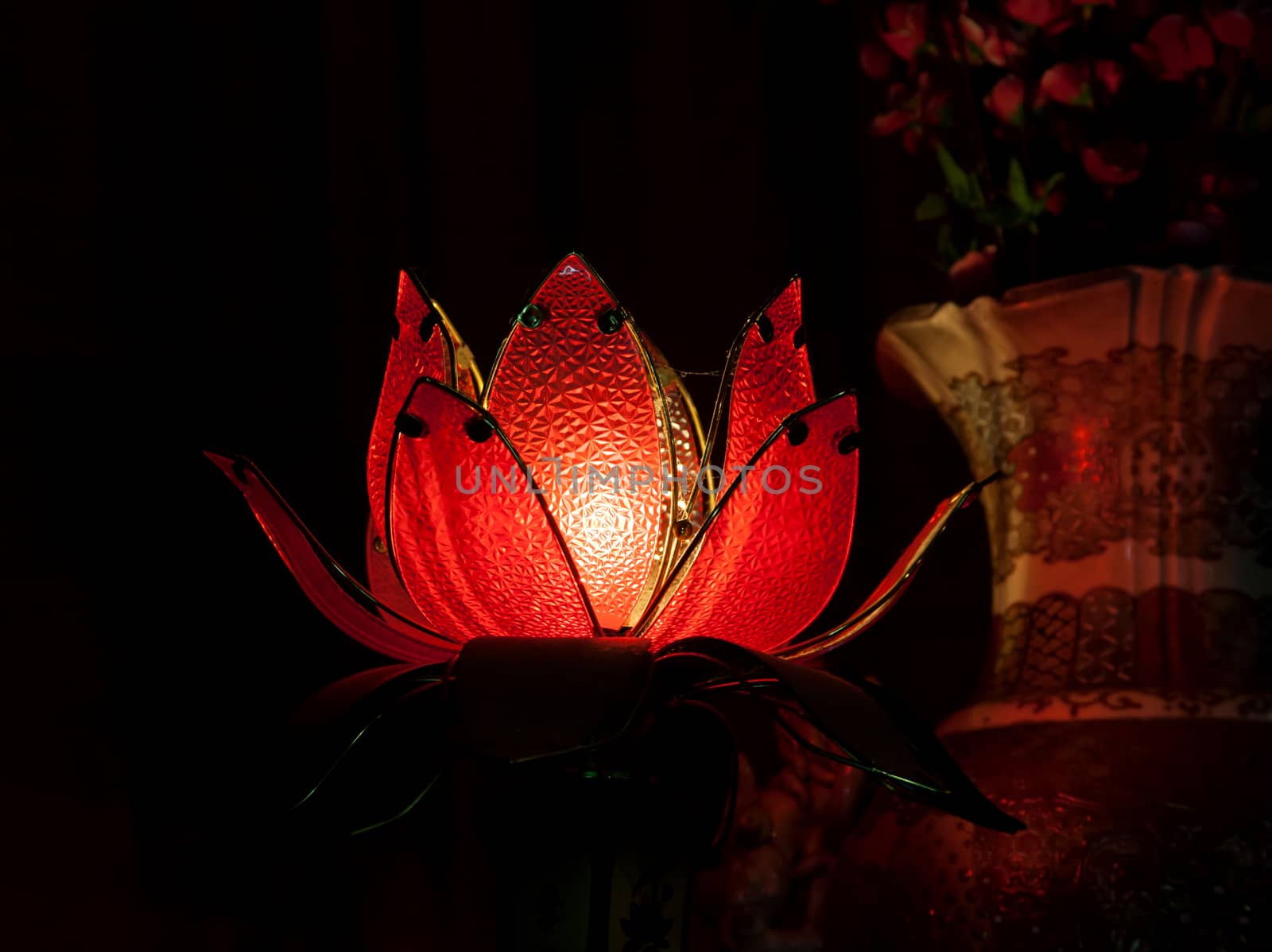 Lotus lamp in a darkness of a buddhist Temple, Vietnam