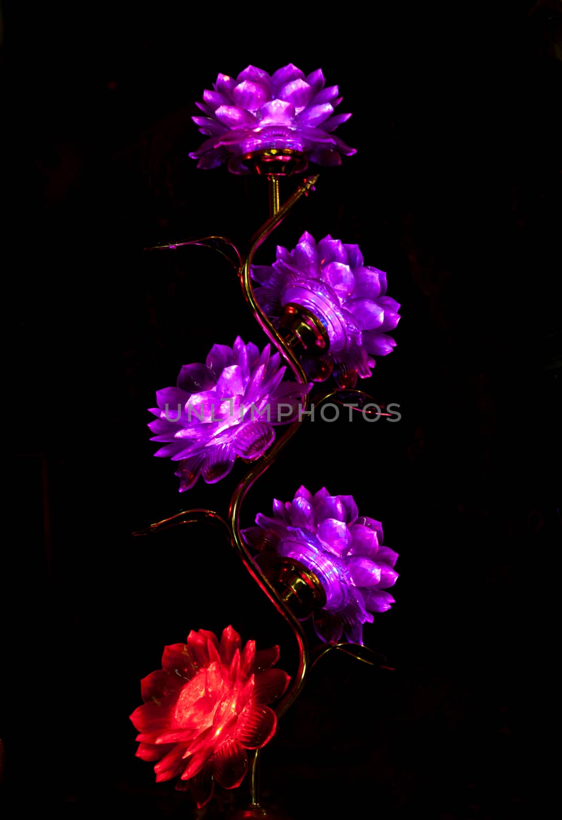 Flower lamp in a darkness of a buddhist Temple, Vietnam