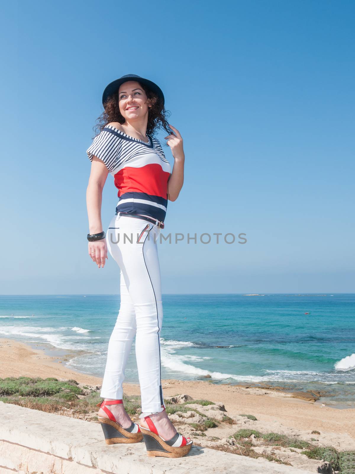 Cheerful girl in blue hat and white jeans by ben44