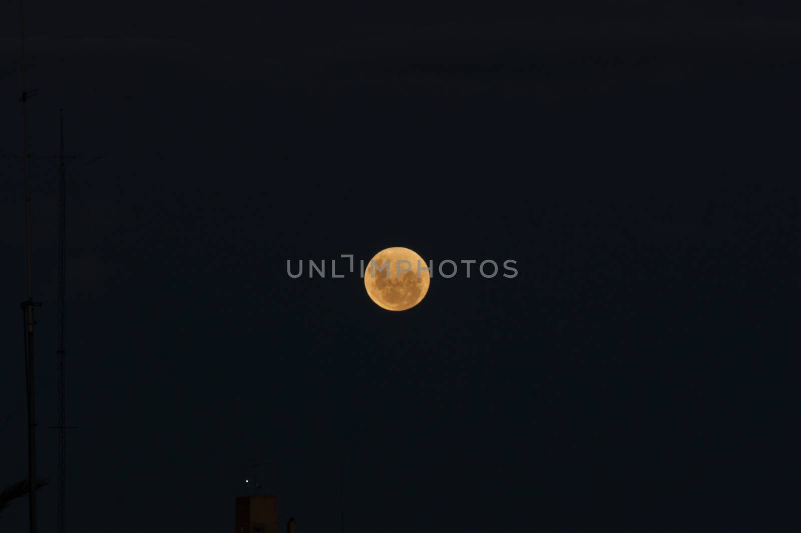 The full moon before the eclipse over a dark sky background
