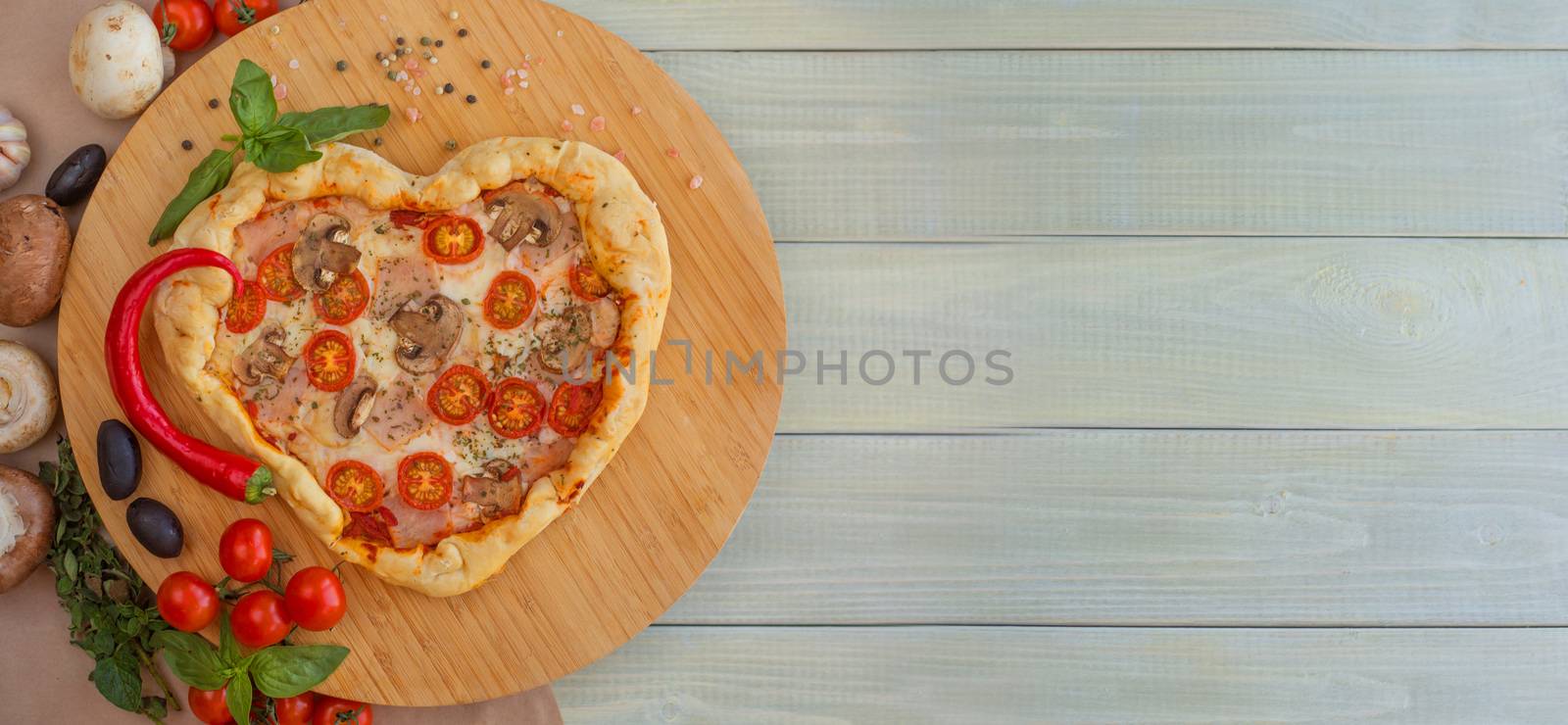 Pizza heart shaped on wood by destillat
