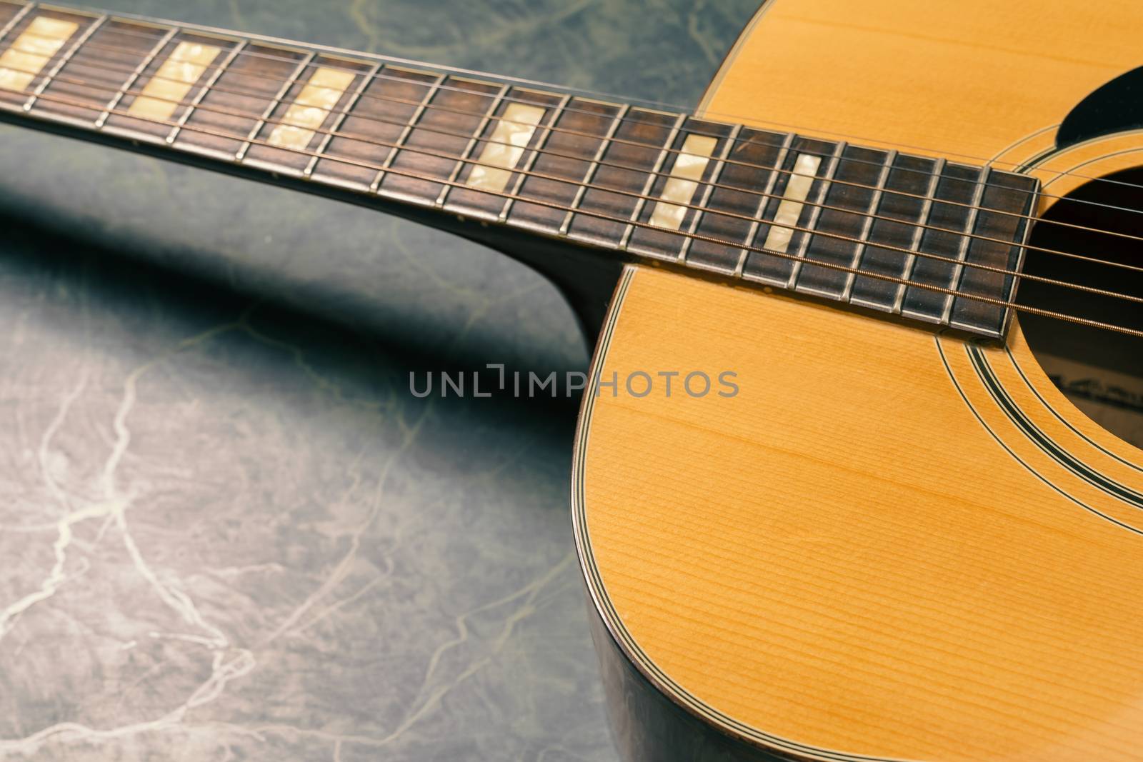 acoustic guitar on green marble background,music concept.