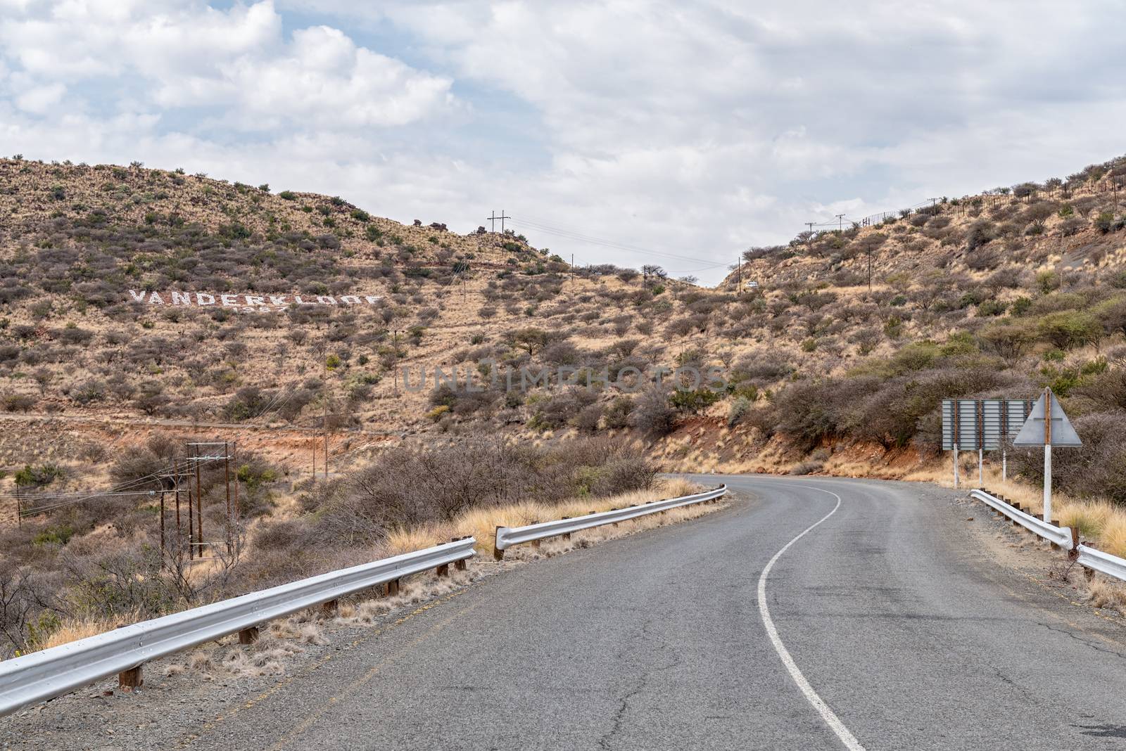 Road to Vanderkloof town in the Northern Cape Province. The name of the town is visible on the side of the hill