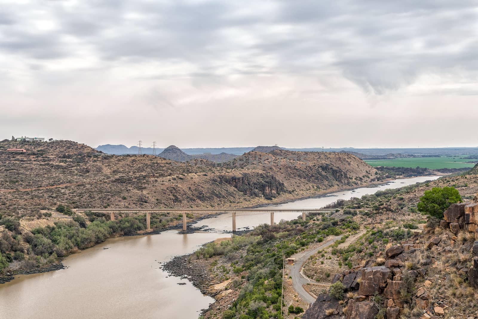 View downstream of the Vanderkloof Dam in the Orange River on the border of the Free State and Northern Cape Provinces. The single lane road bridge is visible