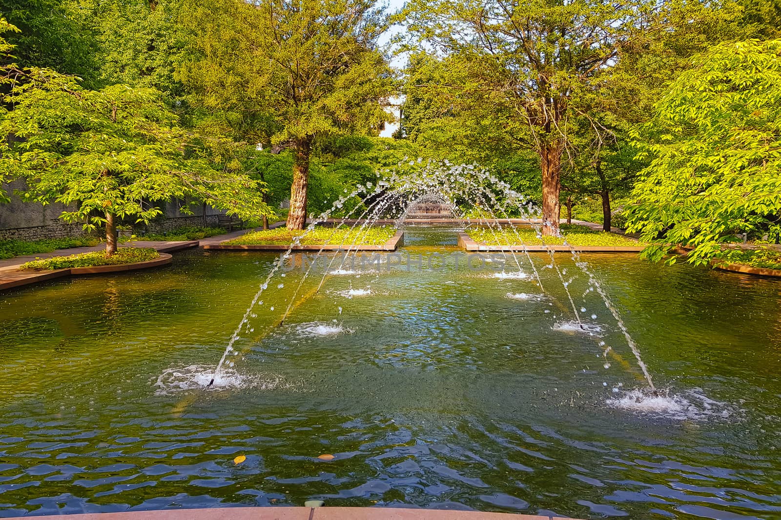 Castle park in summer with fountain in the bright day. Water Environment concept