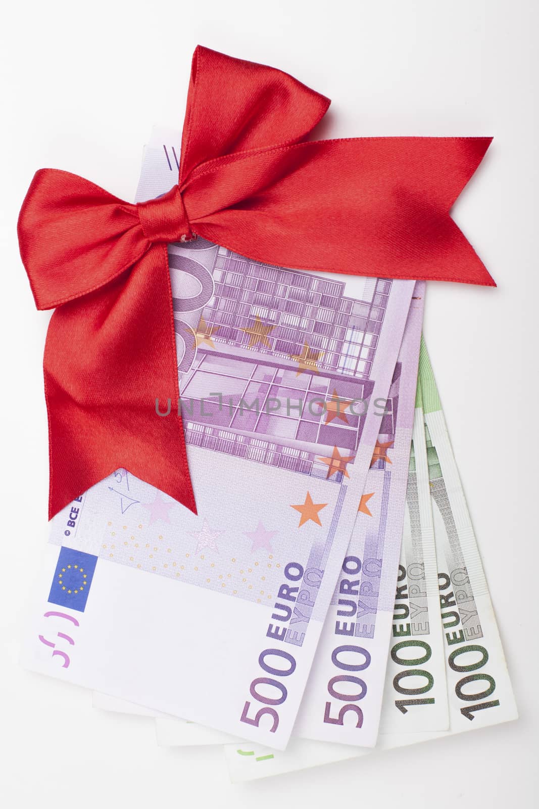 Euro banknotes with red ribbon isolated on white backgroound