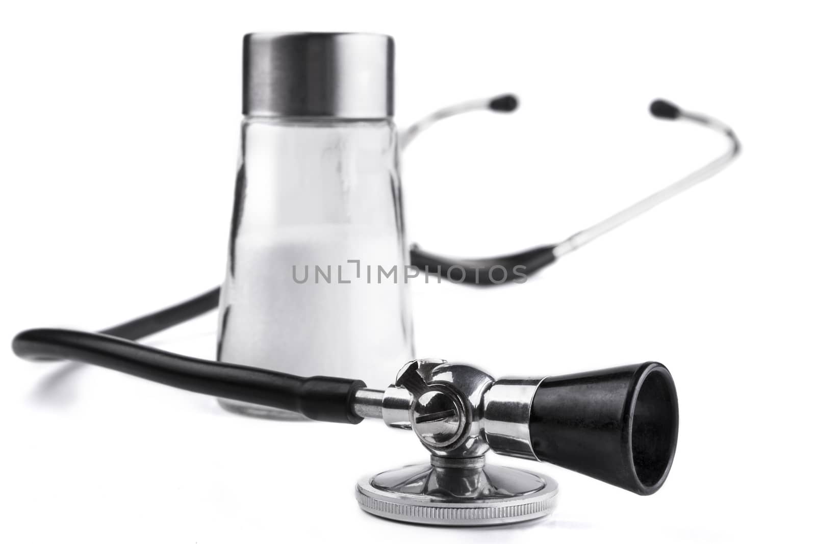 Black stethoscope  closeup with salt  isolated on white background