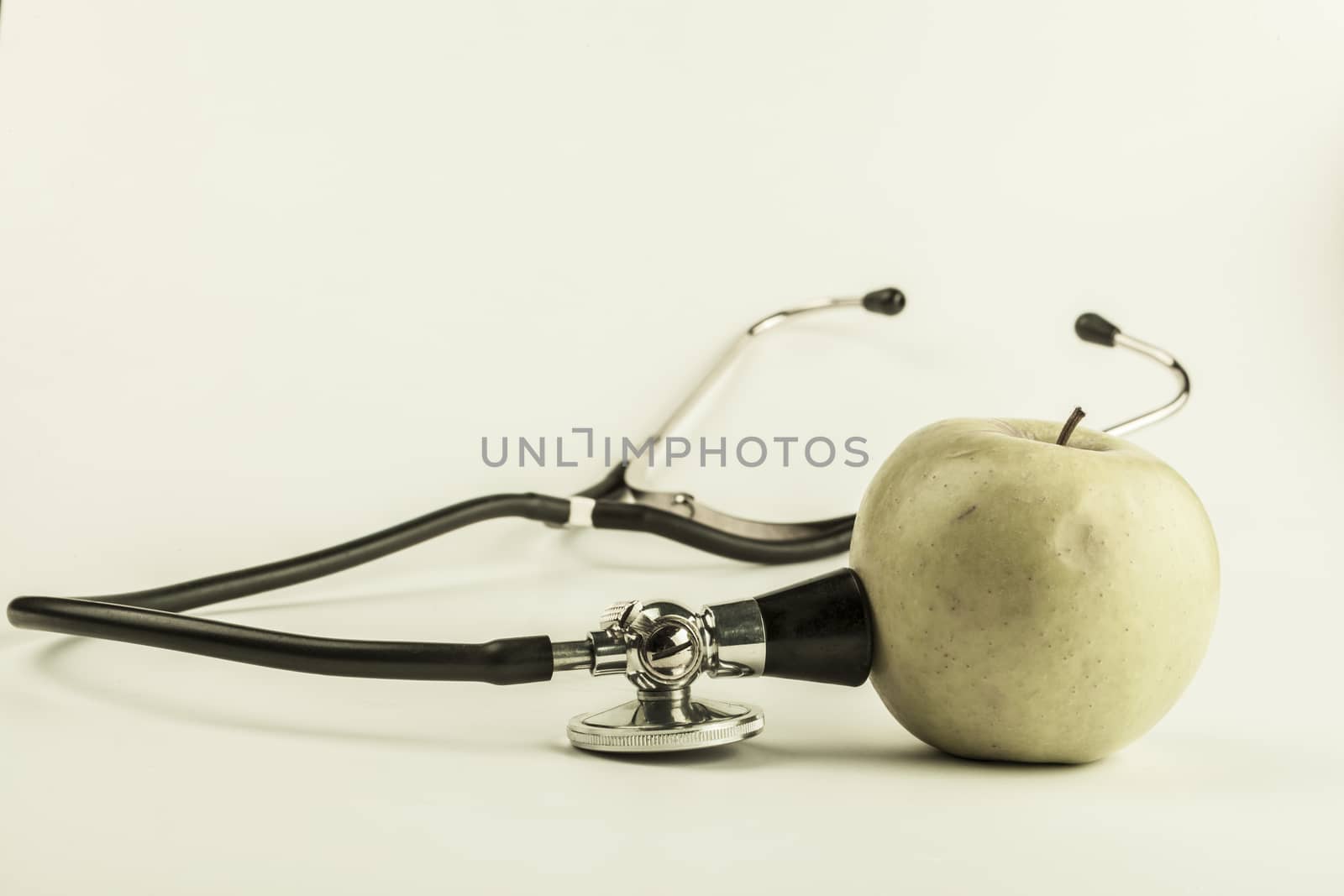 Green ill apple with black stethoscope green type image