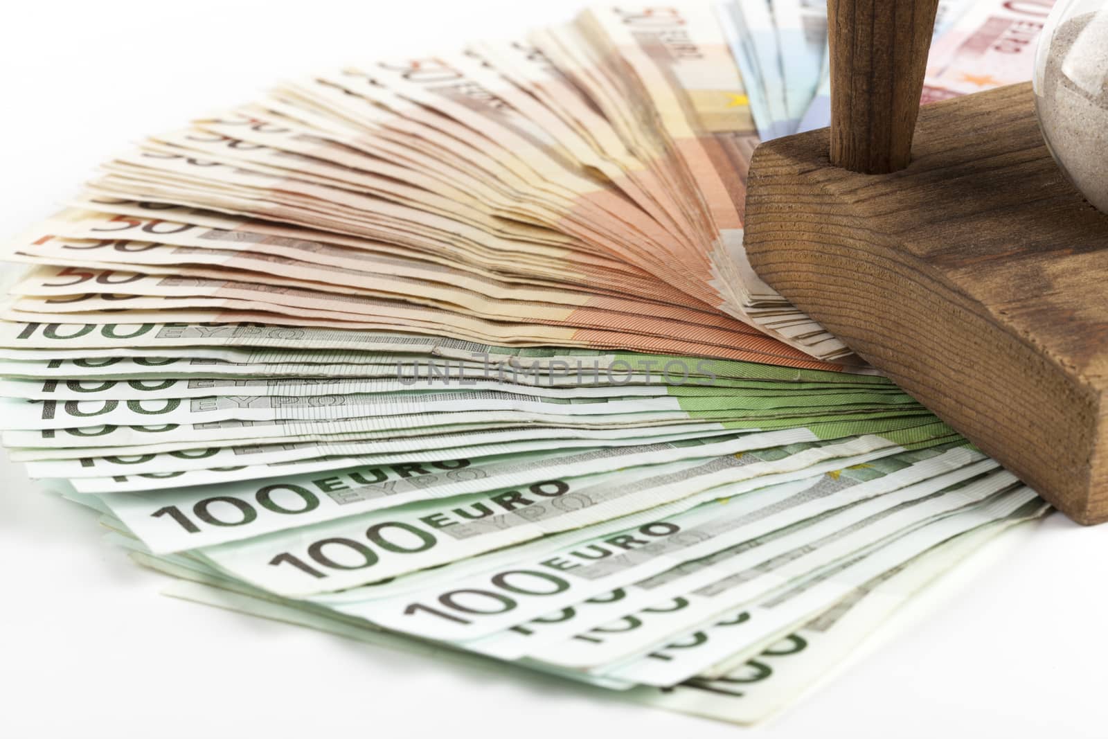 Different euro banknotes with horglass