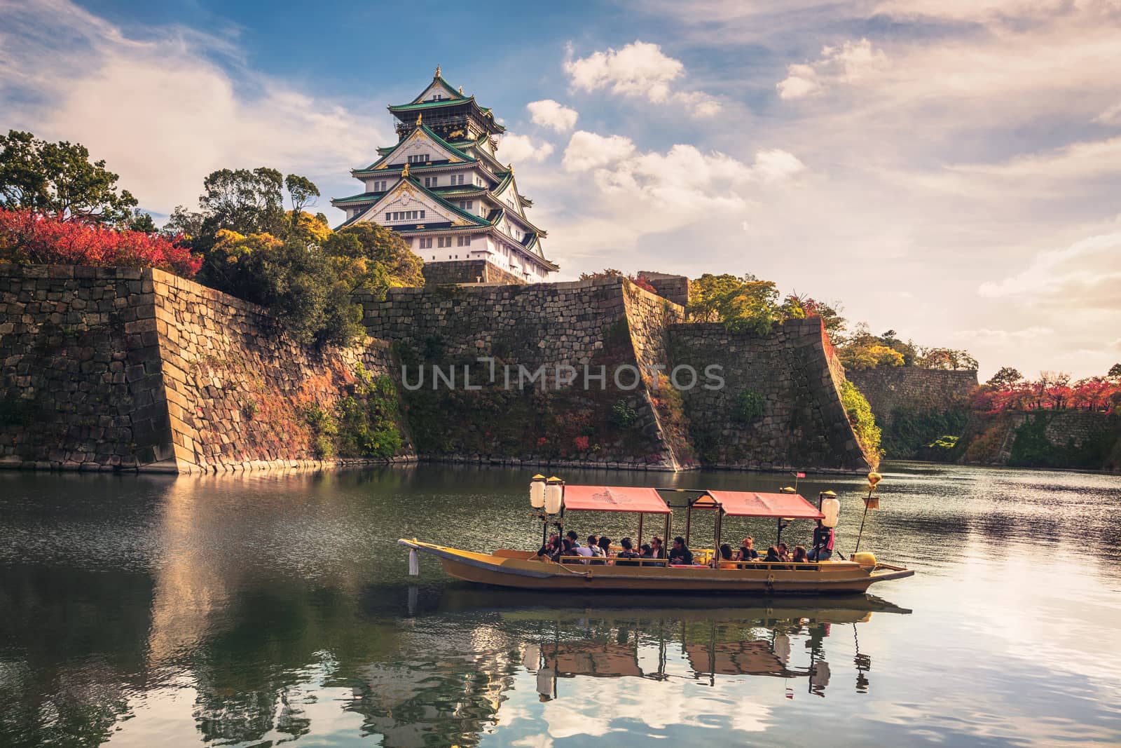 Touristic boats with tourists along the moat of Osaka Castle, Osaka, Japan by zhu_zhu