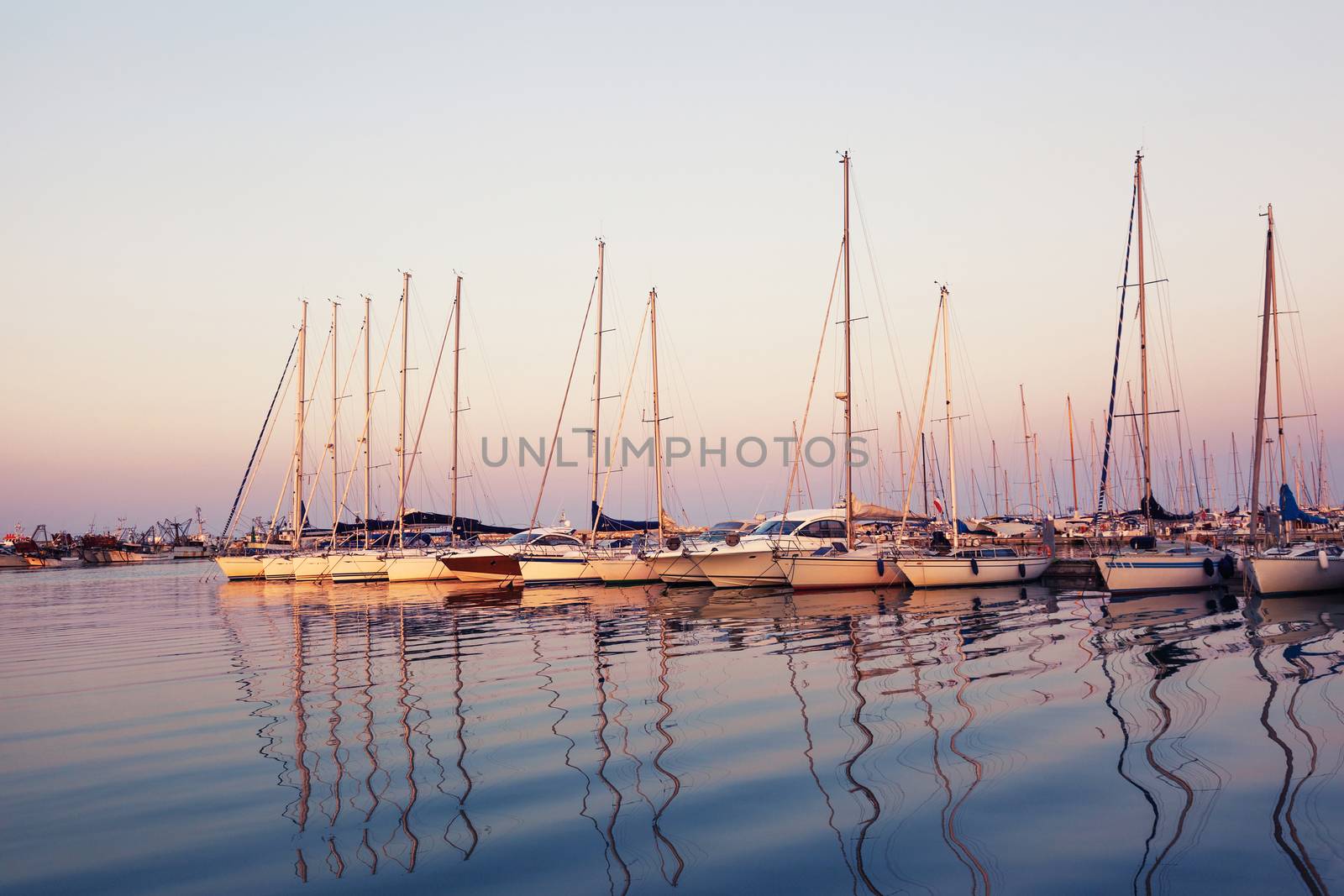 Marina with docked yachts at sunset by zhu_zhu