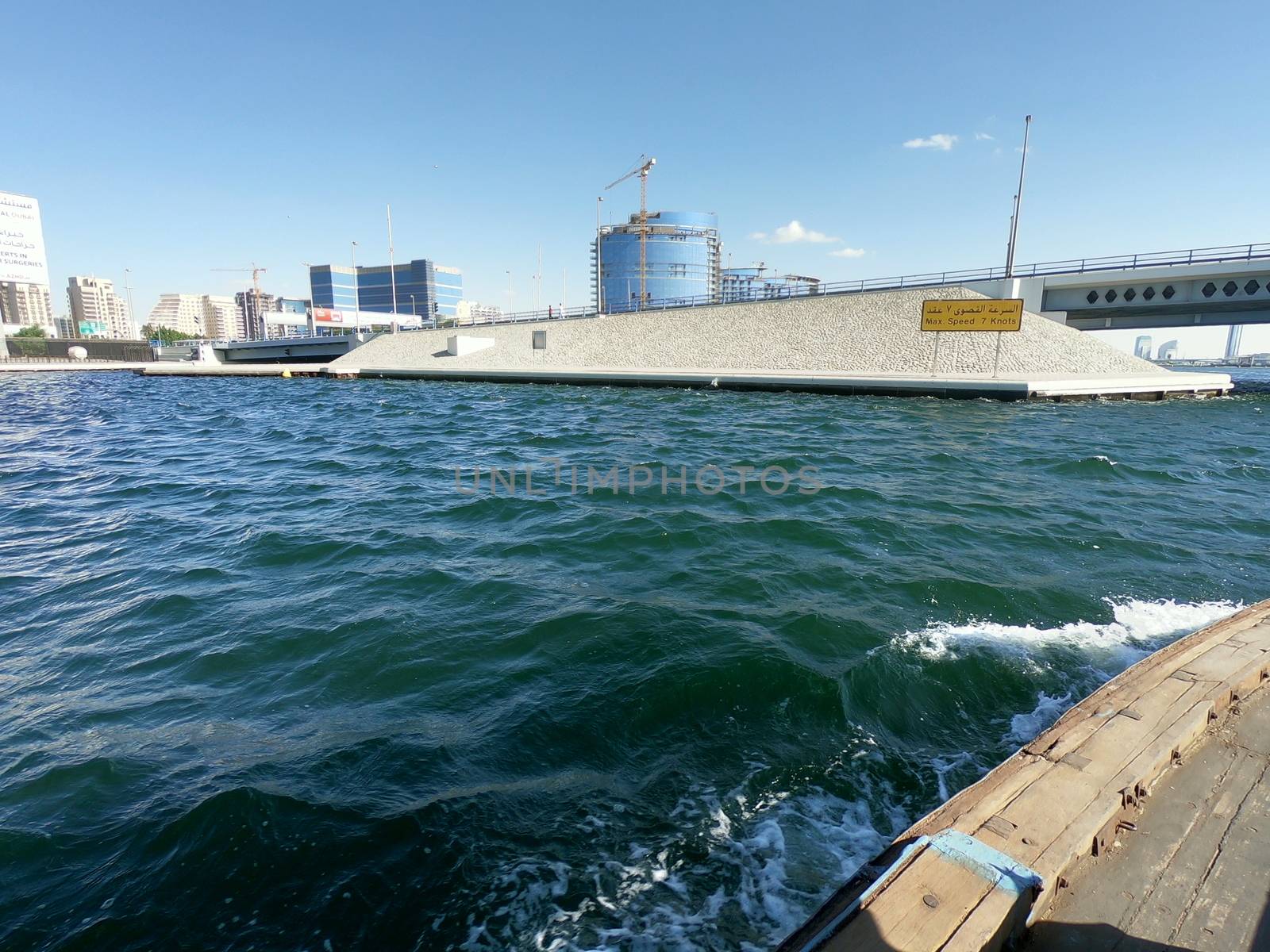 Skyline and Bridge View of Dubai Creek - View of Buildings and water in Day Time Located in Gulf of Dubai by sn040288