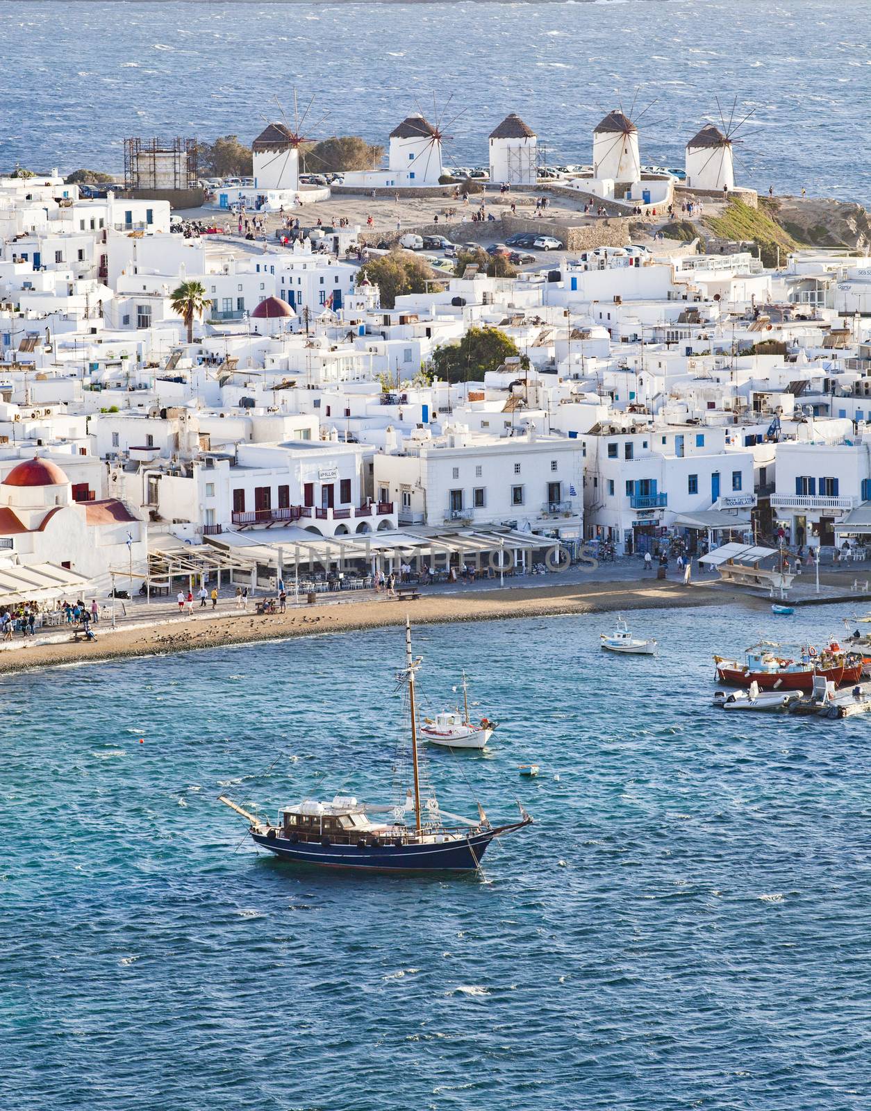 panoramic view of the Mykonos town harbor with famous windmills  by melis