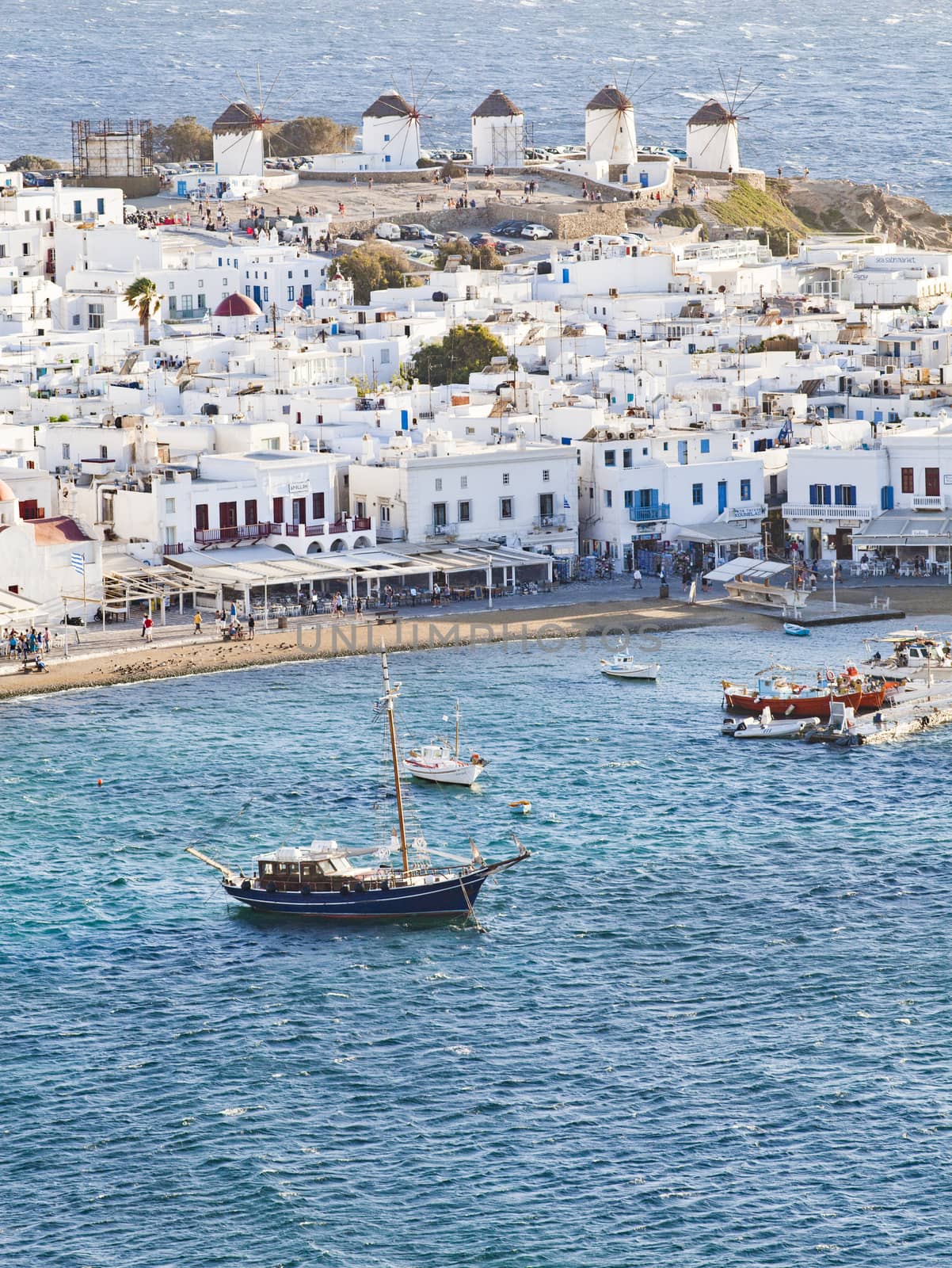 panoramic view of the Mykonos town harbor with famous windmills  by melis