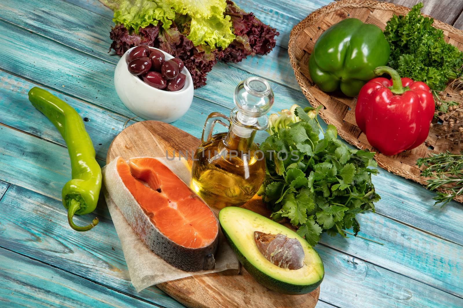 Piece of fish and vegetables on an old wooden desk