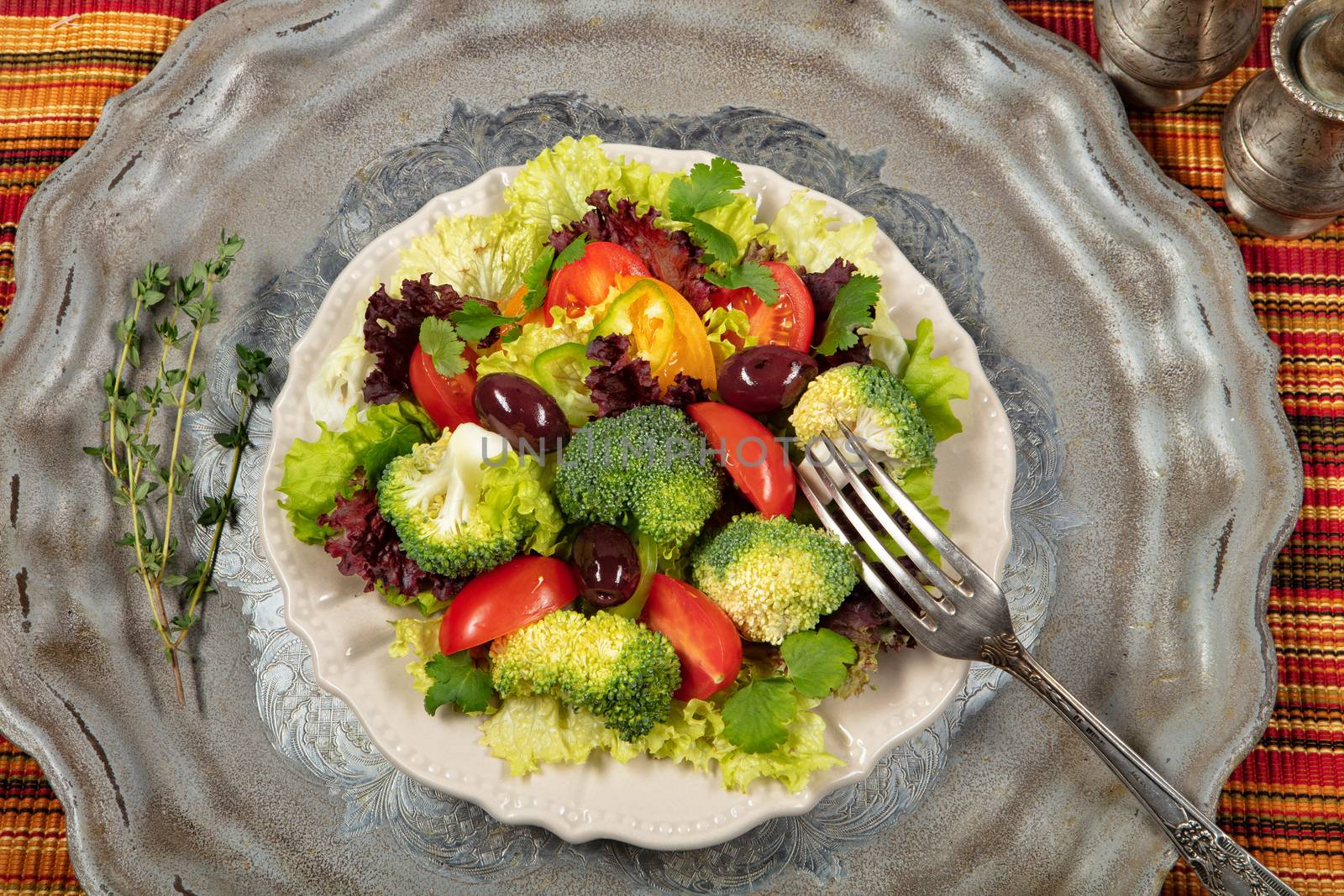Salad with olives on an old metal desk
