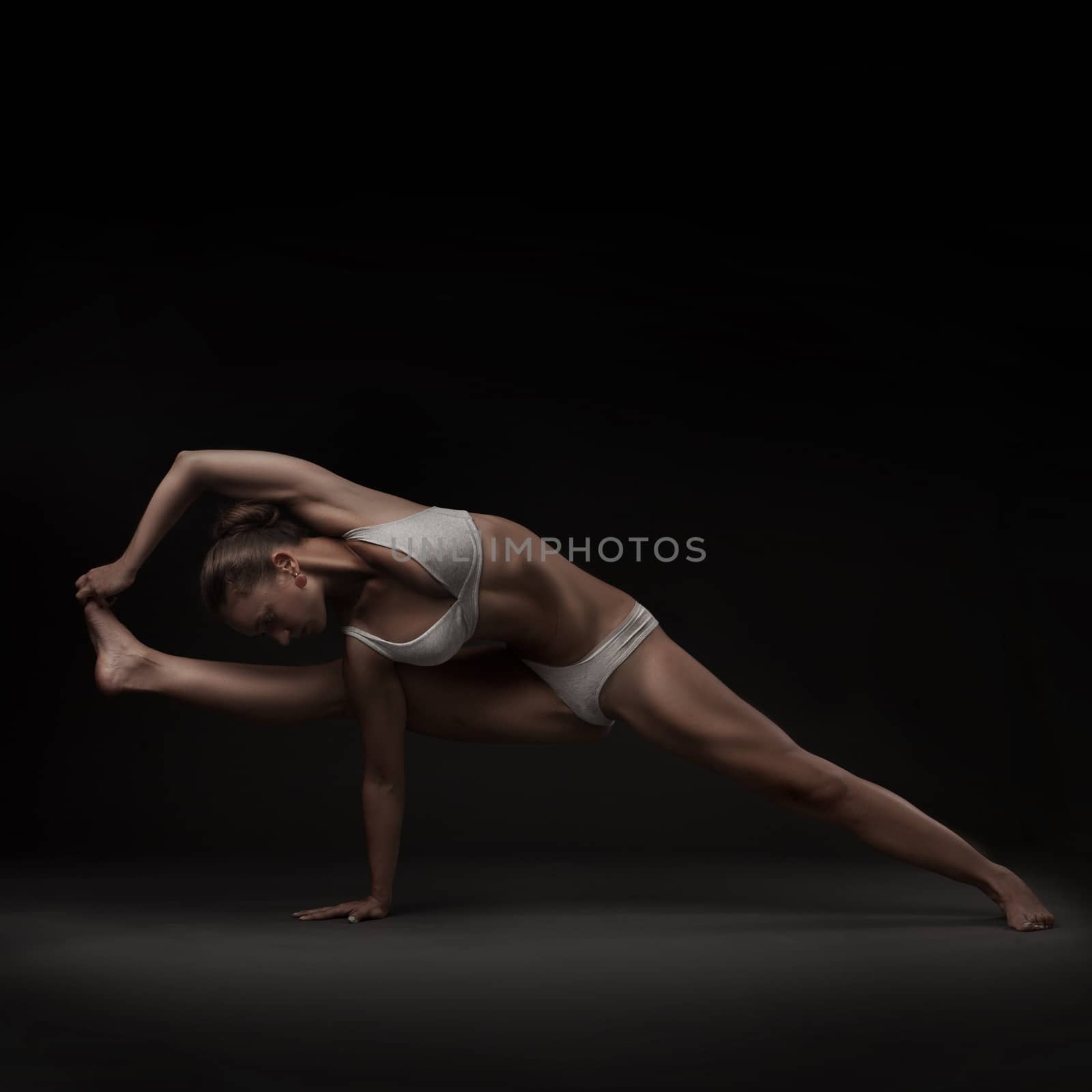 Healthy latino woman doing yoga by doodko