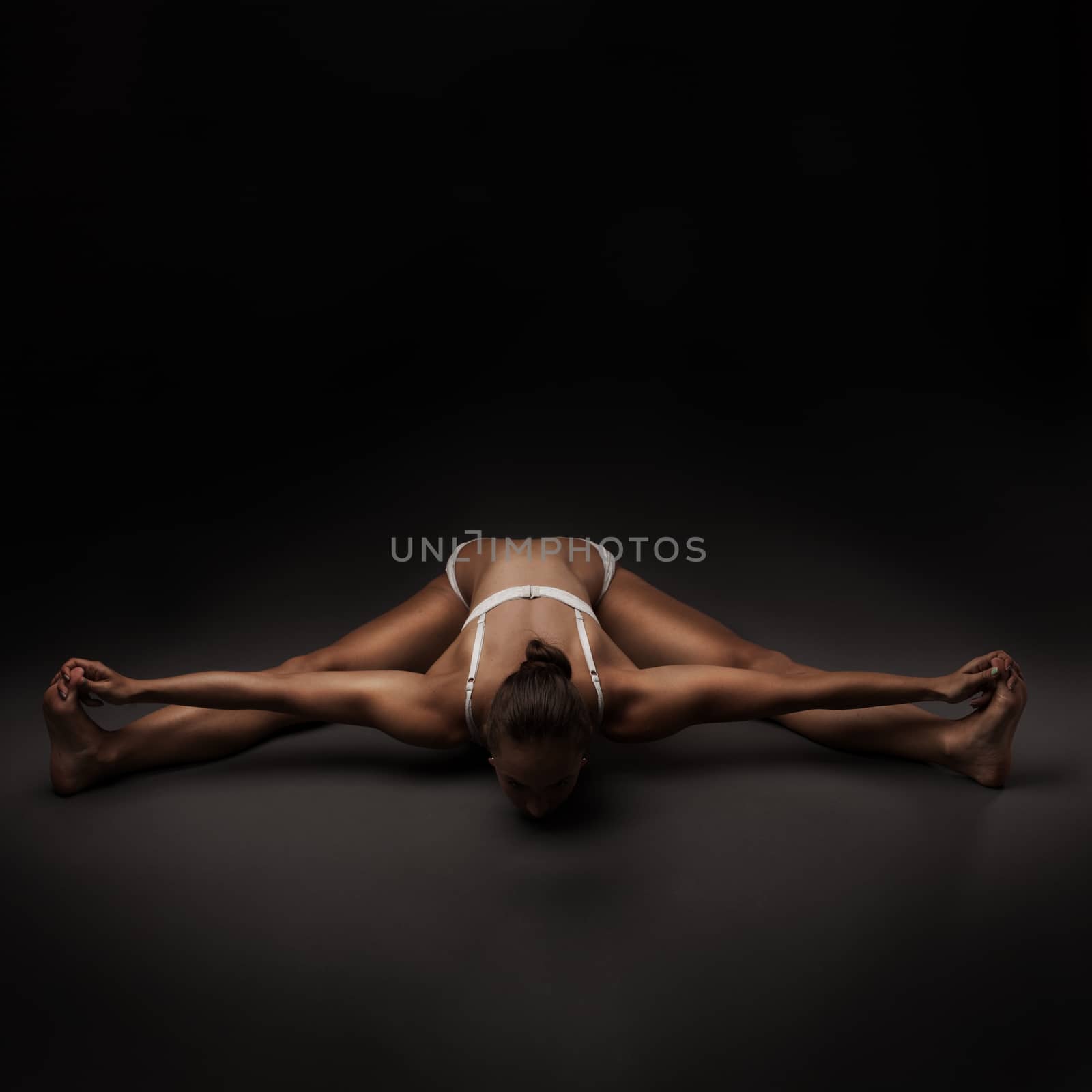 Healthy latino woman doing yoga by doodko