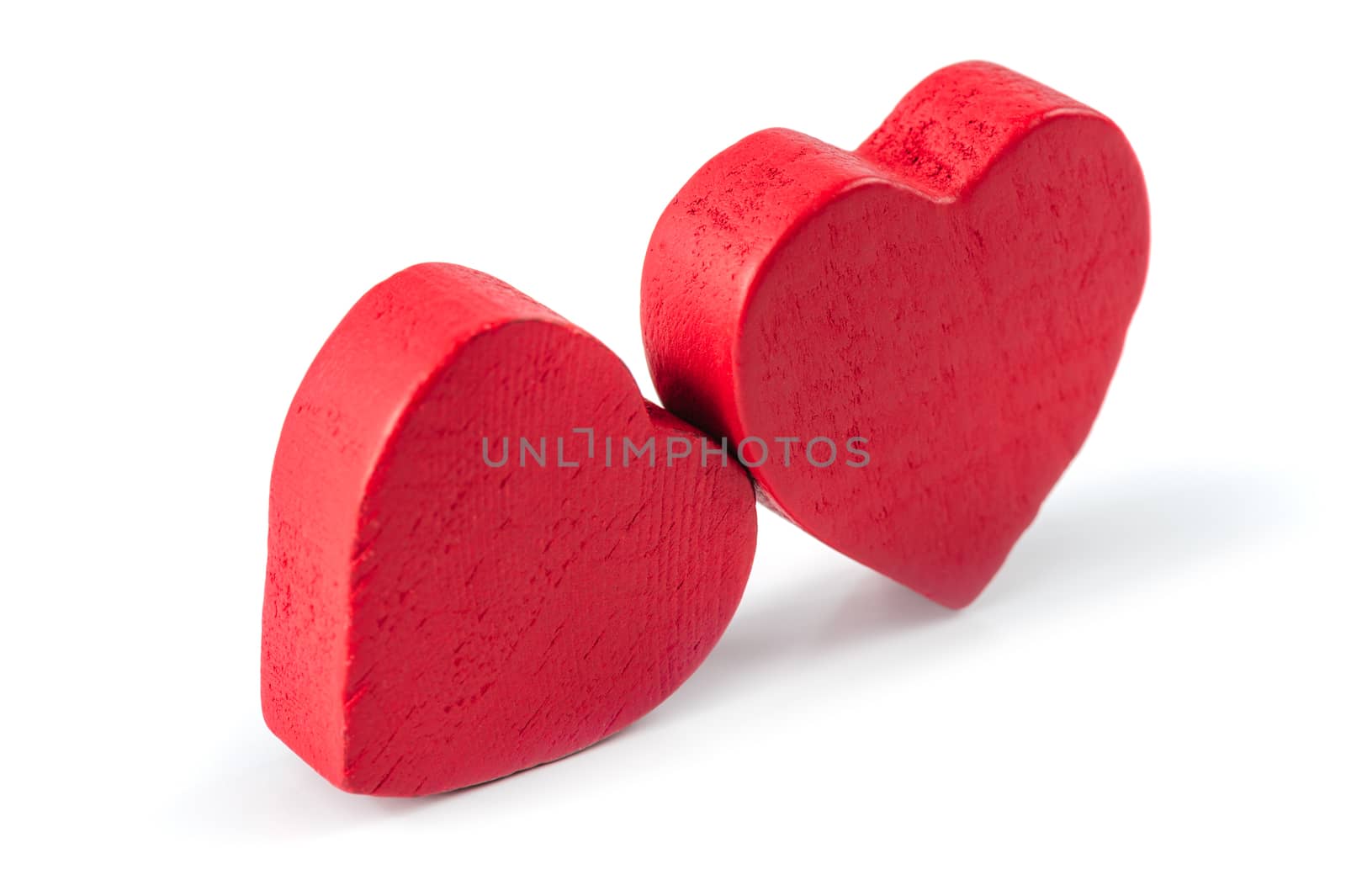 Red wooden roughly carved hearts isolated on white