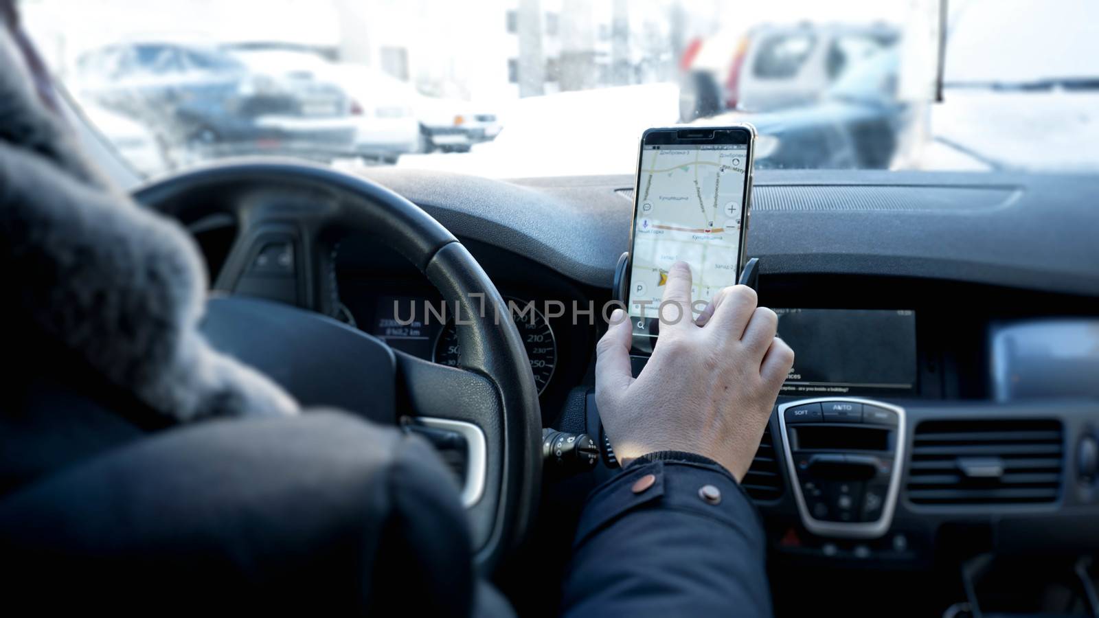 Transport, destination, modern technology and people concept - male hand searching for route using navigation system on car mobile screen