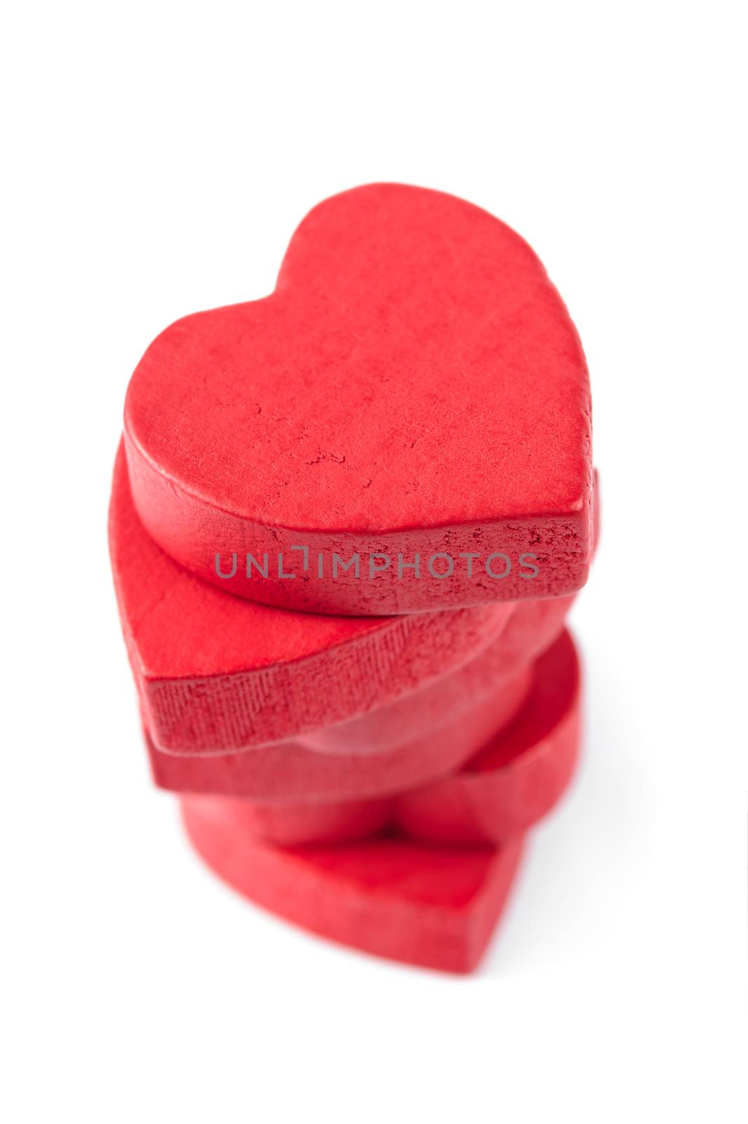 Stack of red wooden hearts, isolated on white by starush