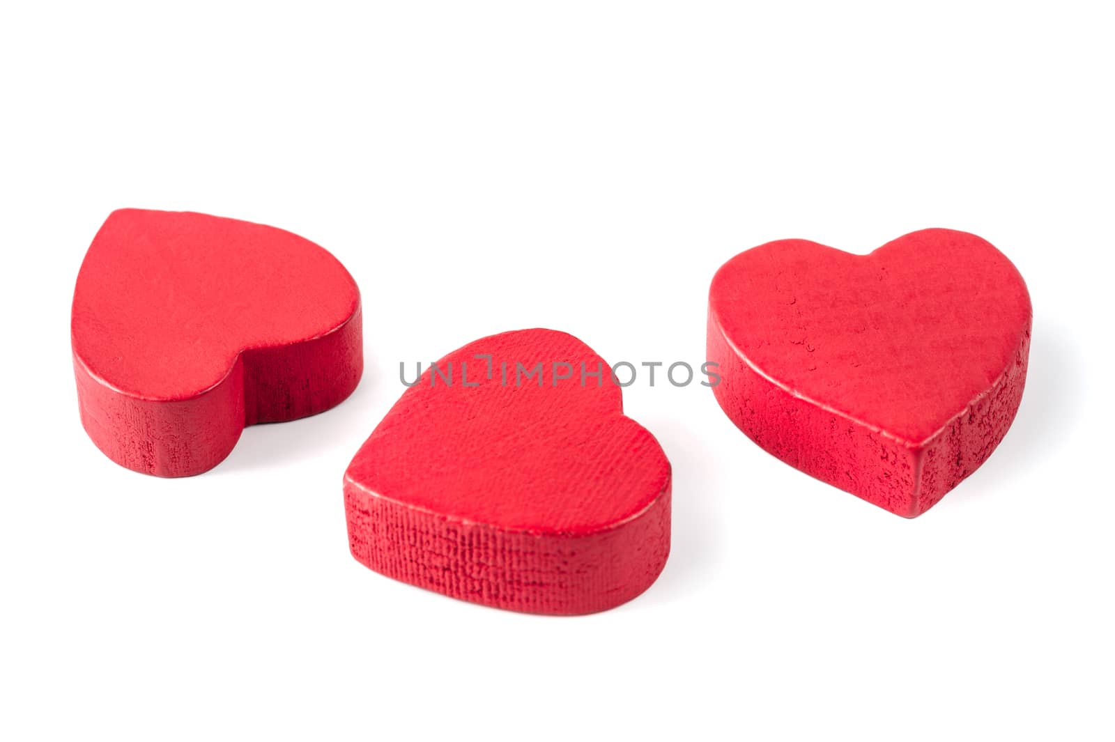 Three red wooden hearts isolated on white by starush