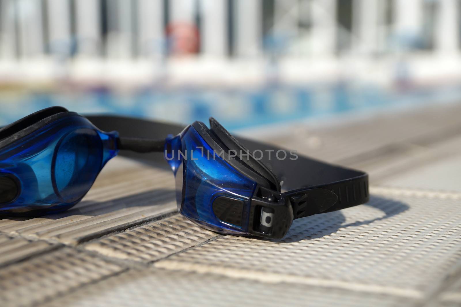 Goggles for swimming on a pool side by Vadimdem